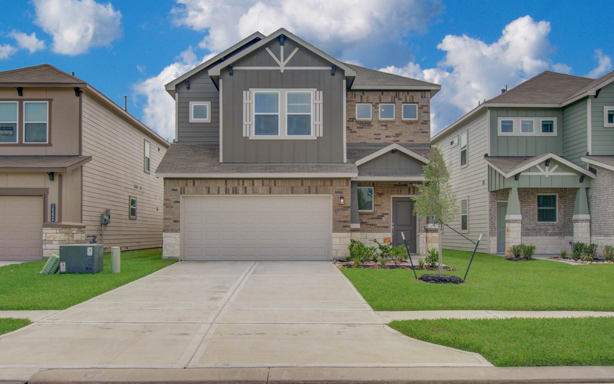 Charming two-story home with a mix of brick and siding, featuring a spacious double garage and a neatly landscaped front yard. Please Note this is a different home/floorplan in the community.