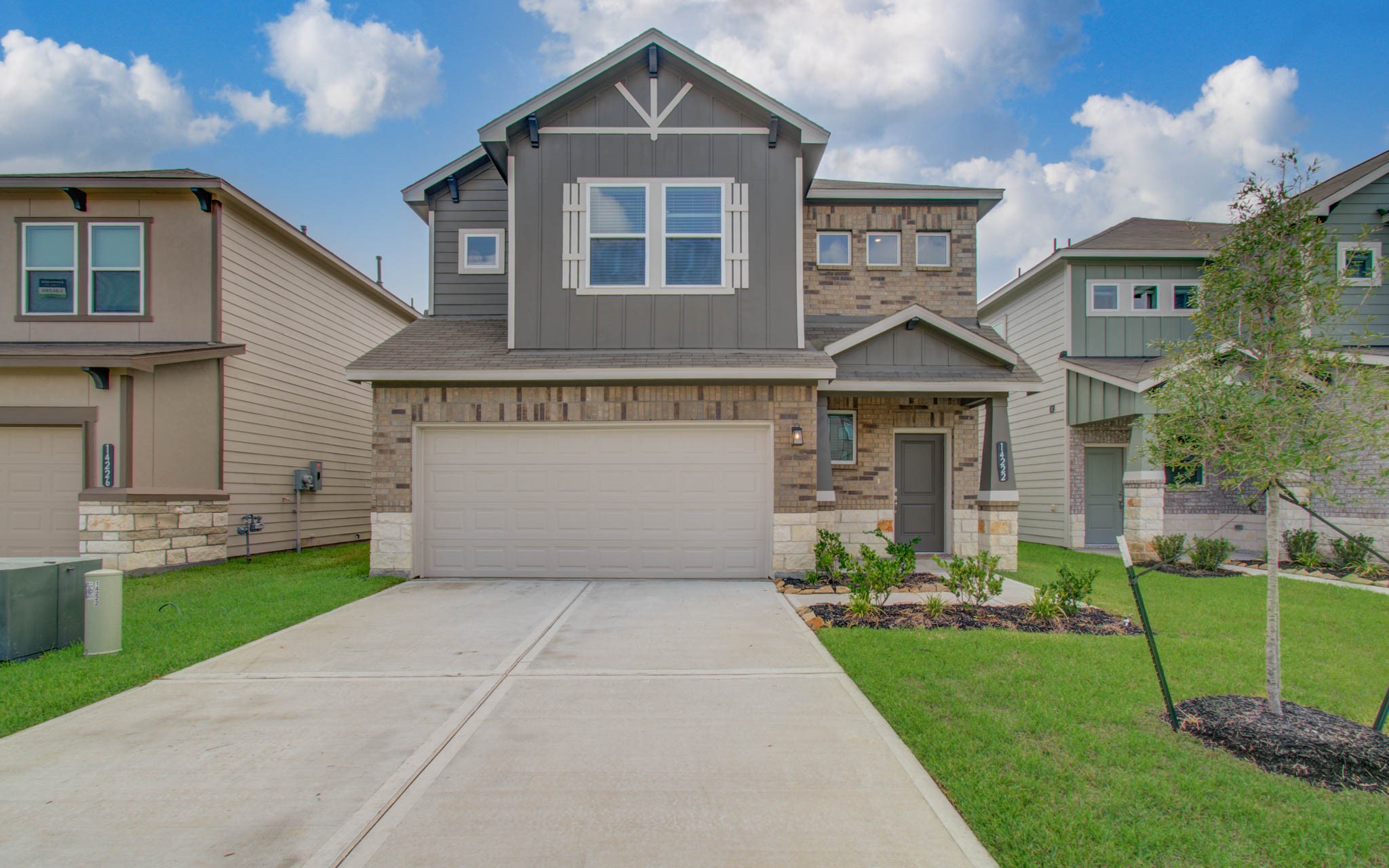 Please Note this is a different home/floorplan in the community. Charming two-story home with a modern facade, featuring a mix of brick and siding, a spacious two-car garage.