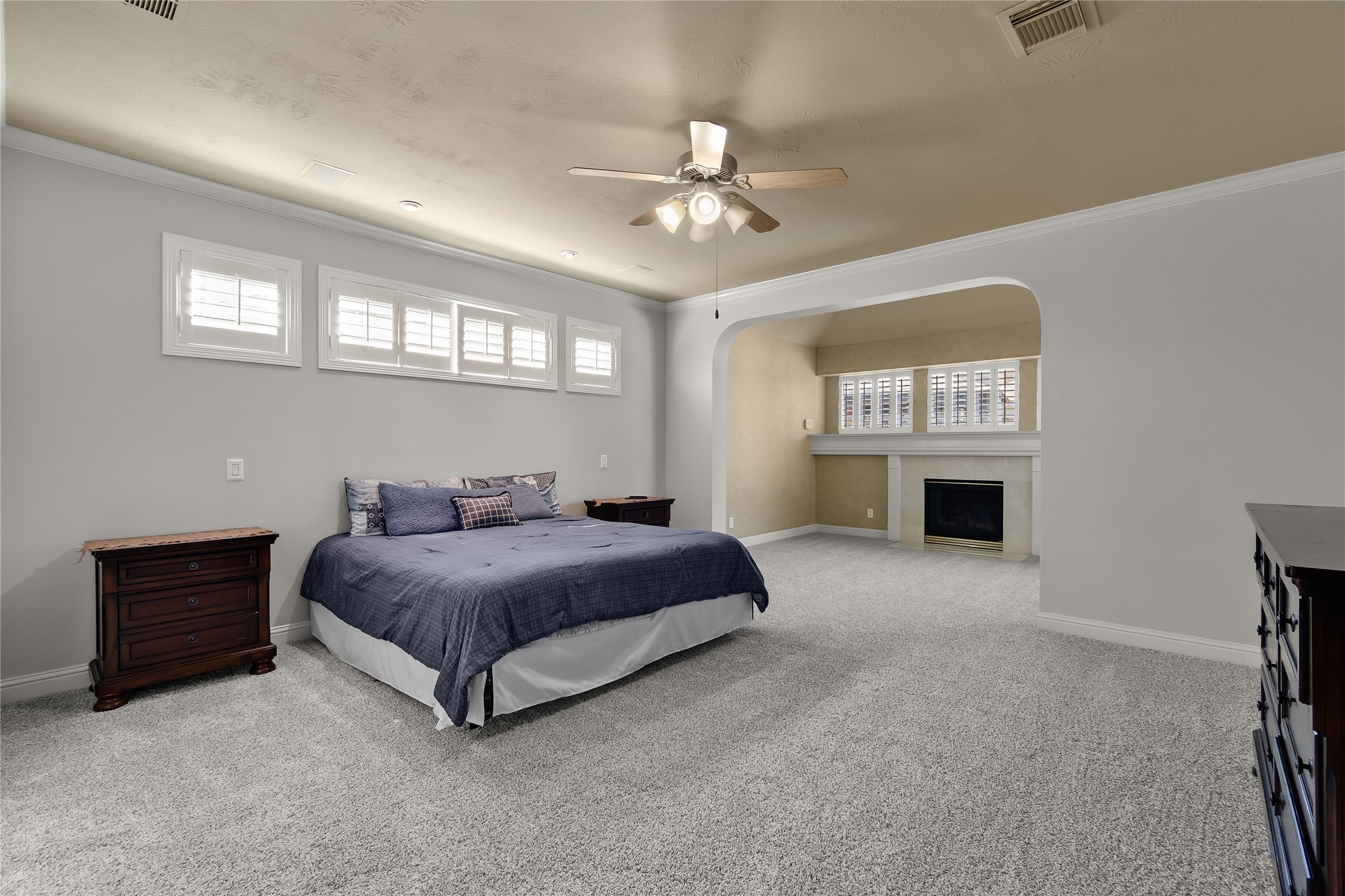A BEAUTIFUL FIRST-FLOOR RETREAT! This generously sized primary bedroom features a raised ceiling, soft neutral finishes and a spacious layout designed for comfort and relaxation.