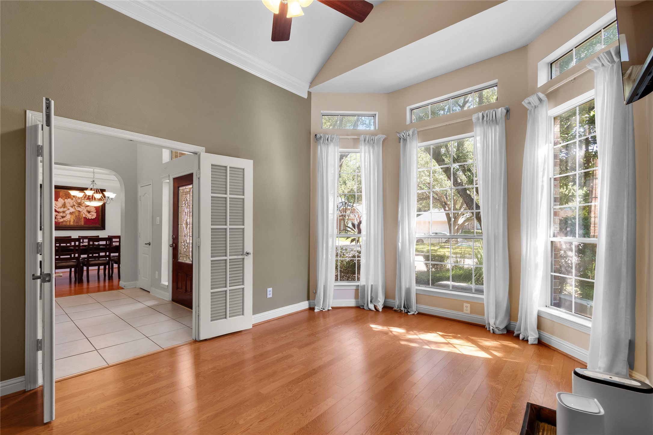 Elegant private study with rich wood flooring, beautiful natural light and generous windows creates an inviting setting for working from home, reading or enjoying a quiet retreat.