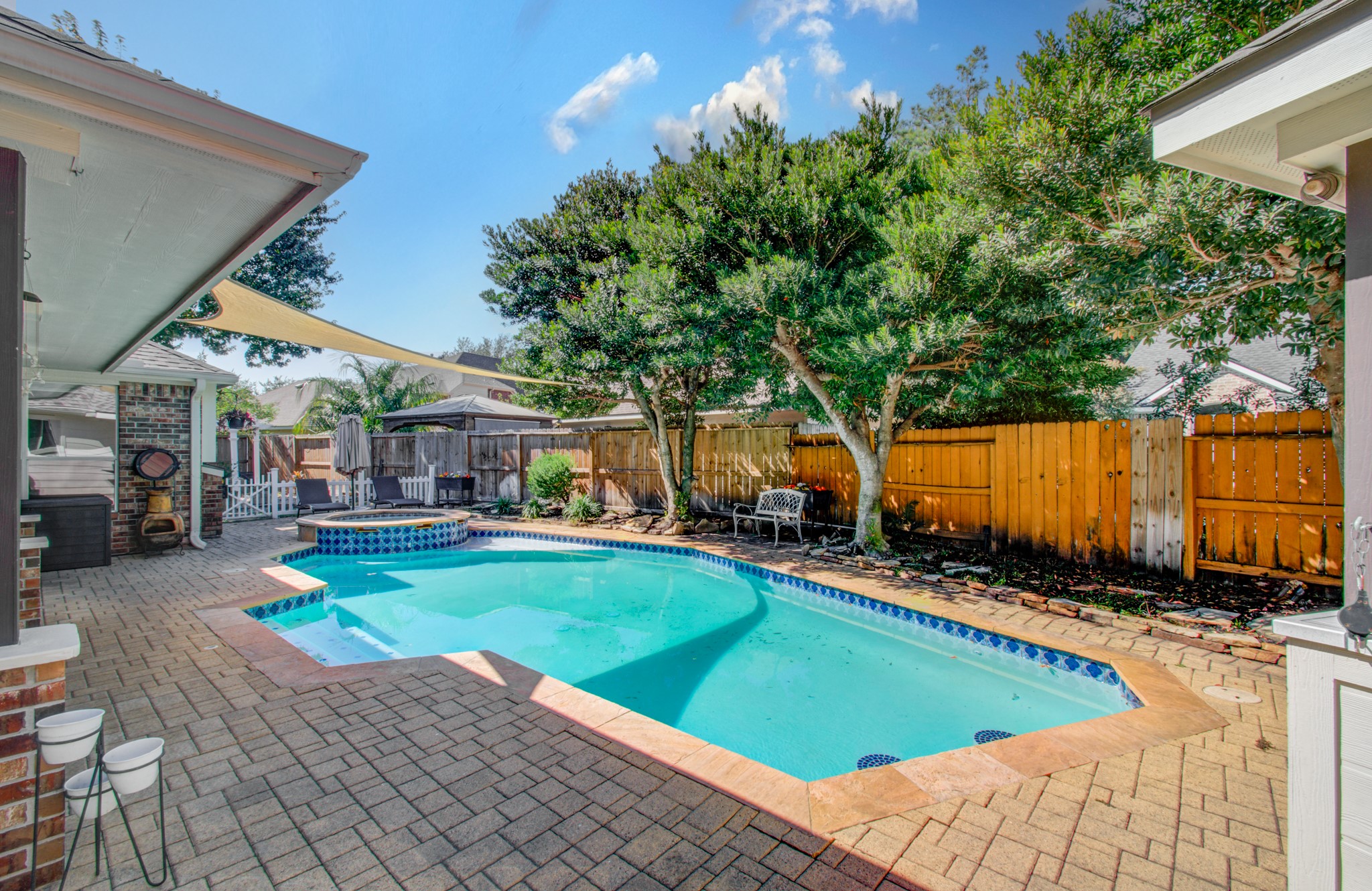 RESORT-STYLE RELAXATION AT HOME! This inviting backyard combines a sparkling pool, raised spa, spacious decking and covered outdoor living for a wonderful blend of recreation and relaxation.