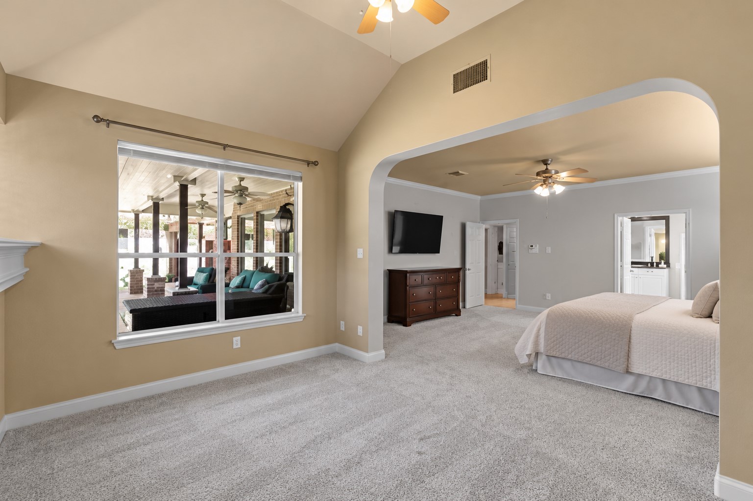 Luxury meets comfort in this exceptional first-floor primary retreat, where an expansive bedroom connects to a separate fireside sitting area filled with natural light. **Virtually Staged**
