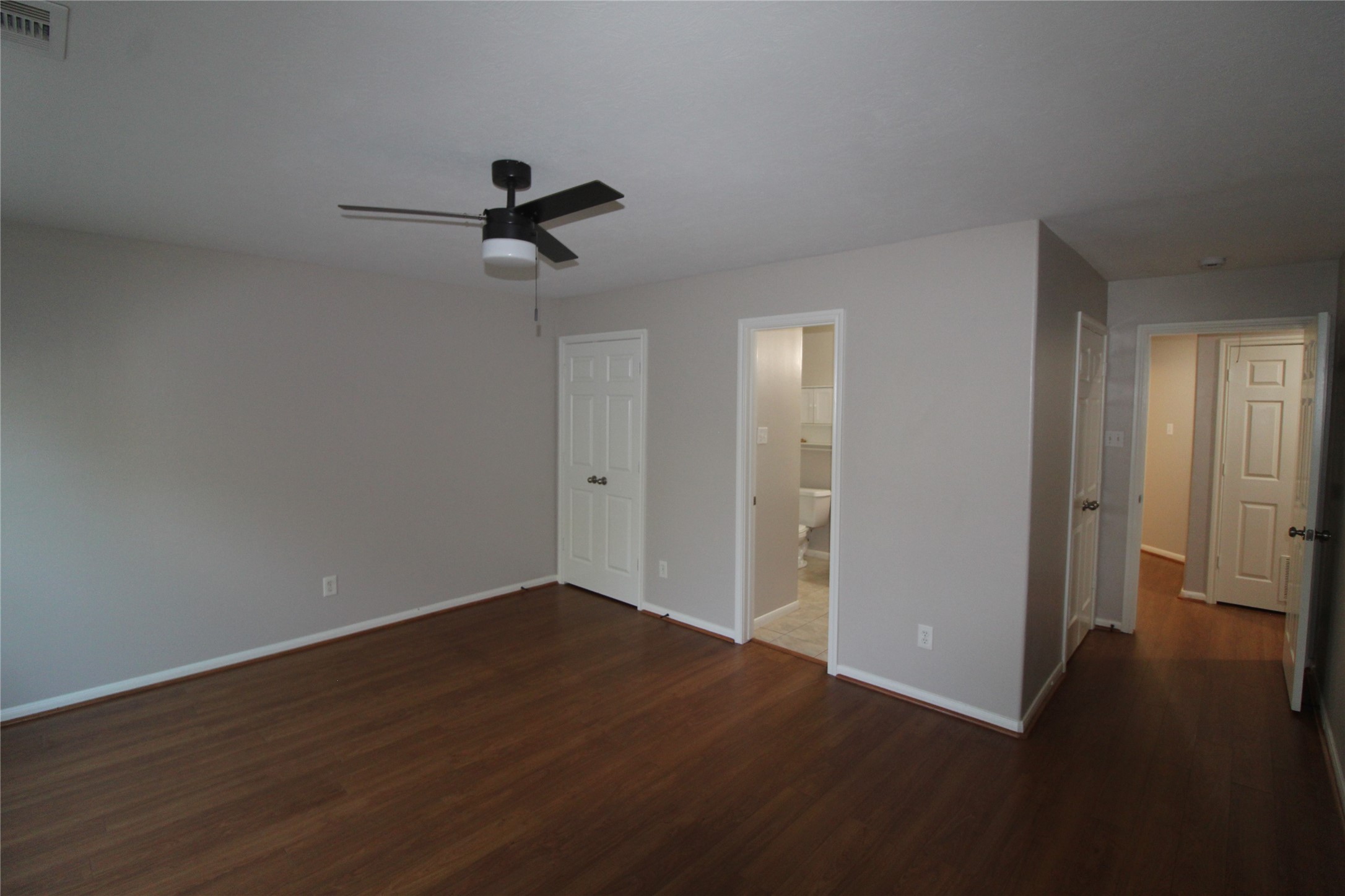 Spacious primary bedroom has dual closets