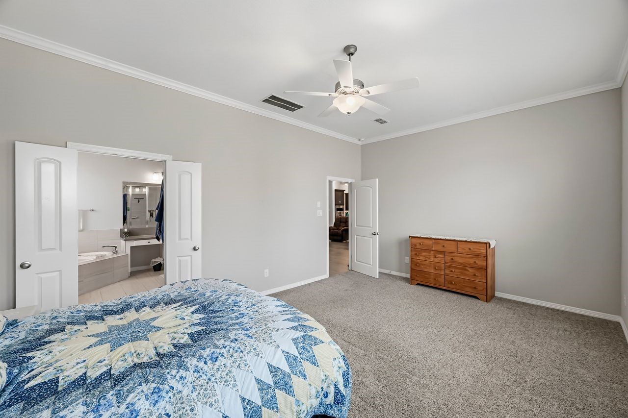 The primary suite offers a serene escape, featuring a glimpse into the spa-like ensuite complete with a soaking tub and dual vanities.