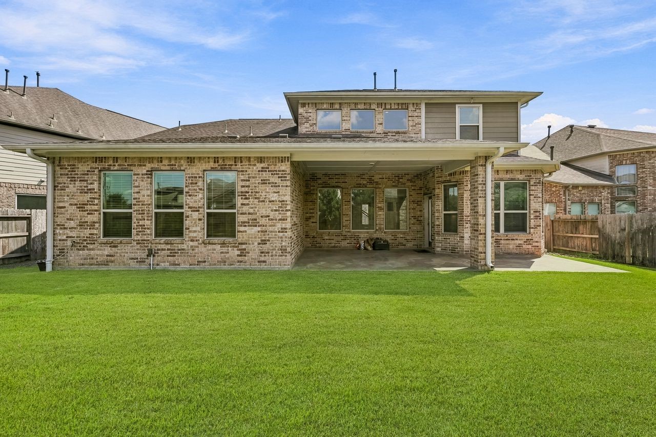 A sophisticated rear elevation showcasing the home's architectural poise and seamless connection to the outdoor living space.
