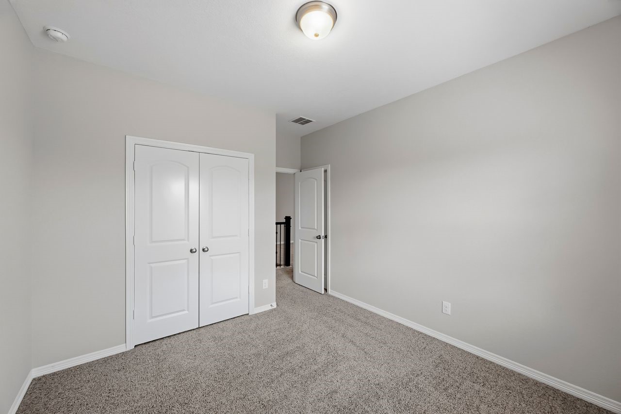 An alternate perspective of the guest suite, highlighting the streamlined entry and integrated closet storage.