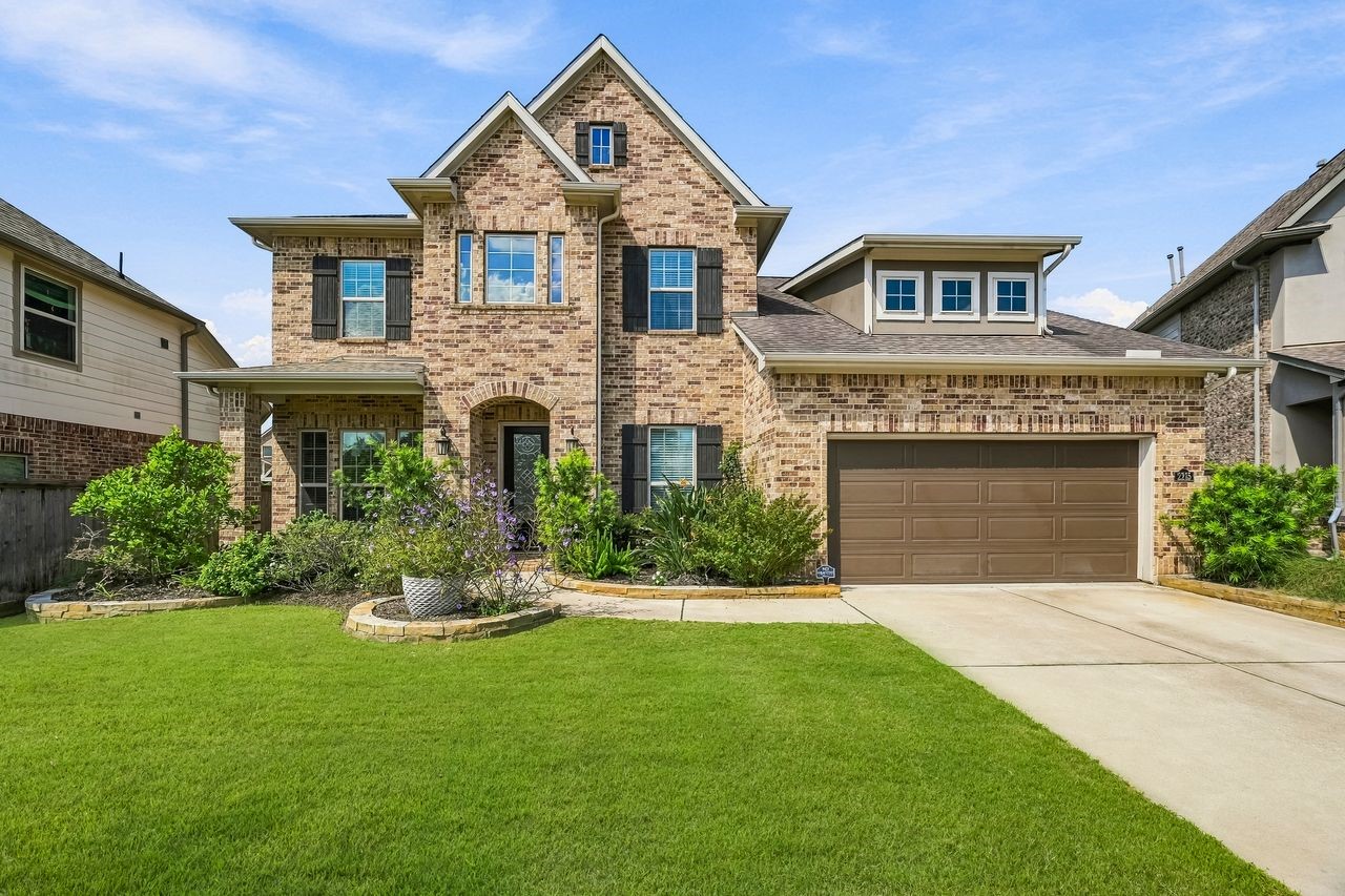 Stately brick accents and expansive windows define this refined exterior, complemented by manicured landscaping and a lush, sprawling lawn. Stately brick accents and expansive windows define this refined exterior, complemented by manicured landscaping and a lush, sprawling lawn.