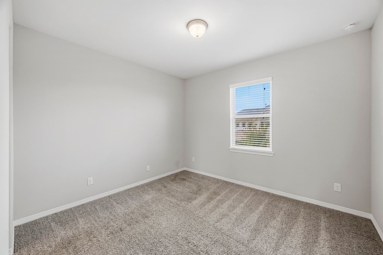 One of two secondary bedrooms featuring a shared en suite bathroom.