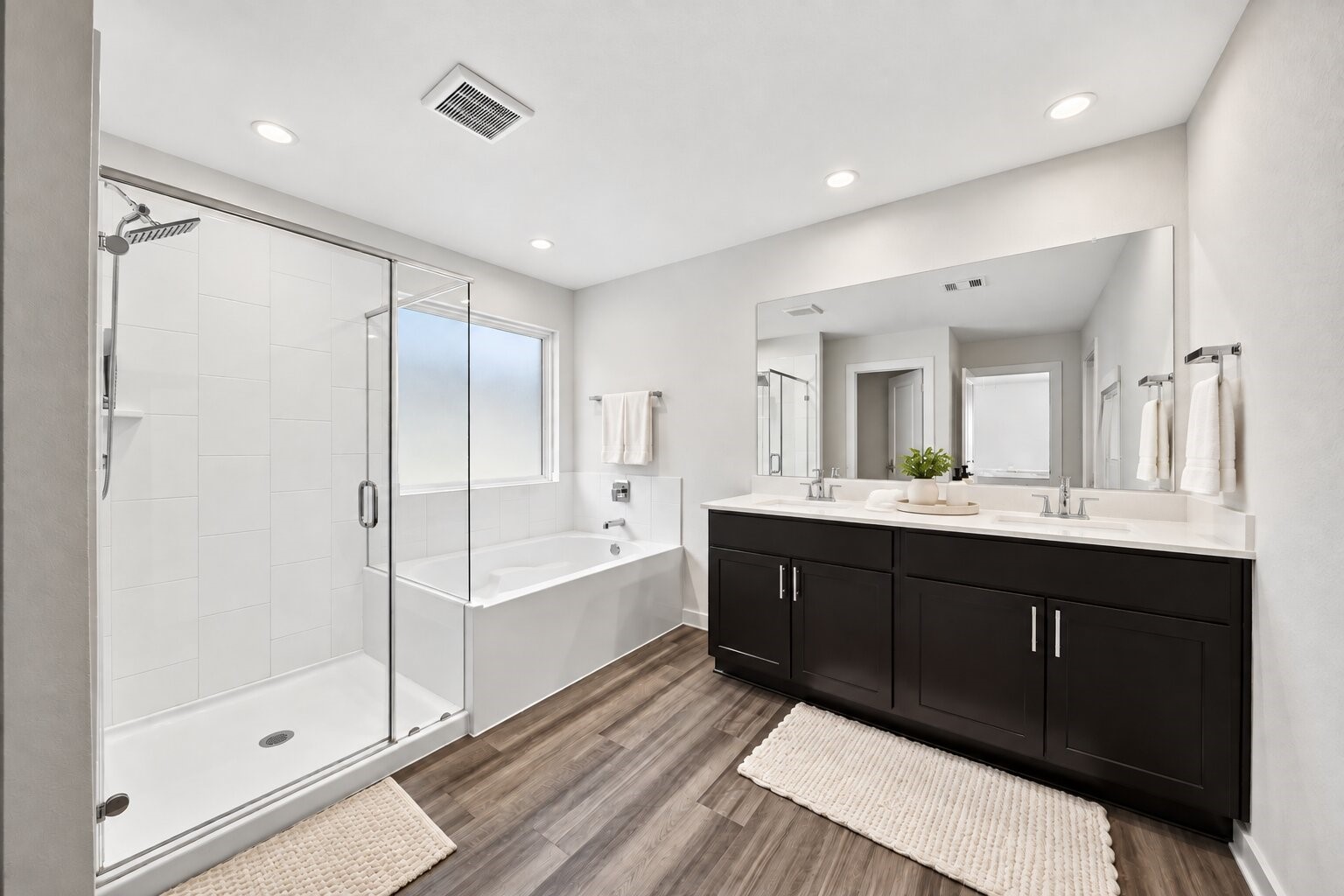 Your everyday routine gets a touch of convenience with a double-sink vanity and tub-shower combination.
