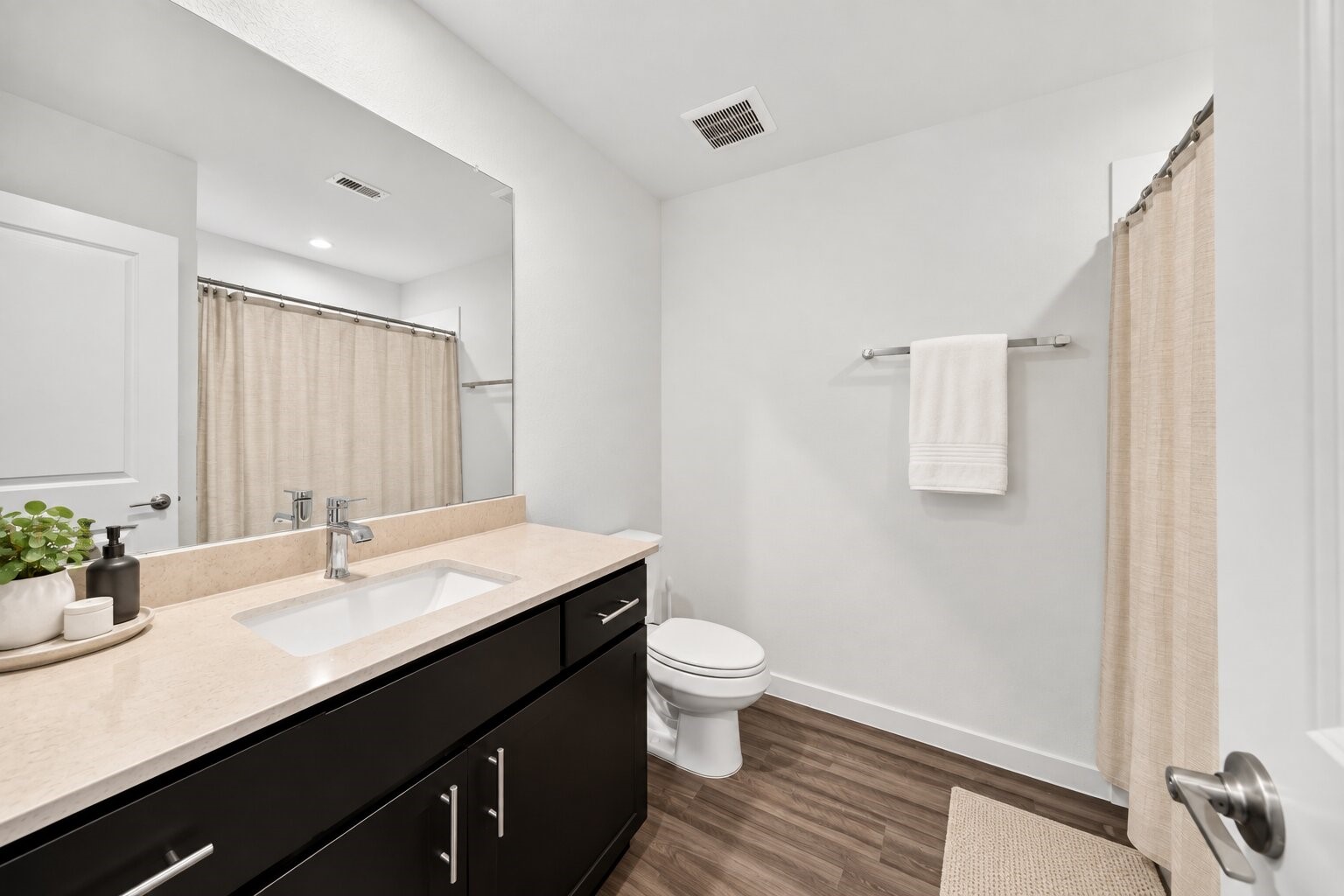 A bathtub and vanity, offering a comfortable space to refresh and unwind.