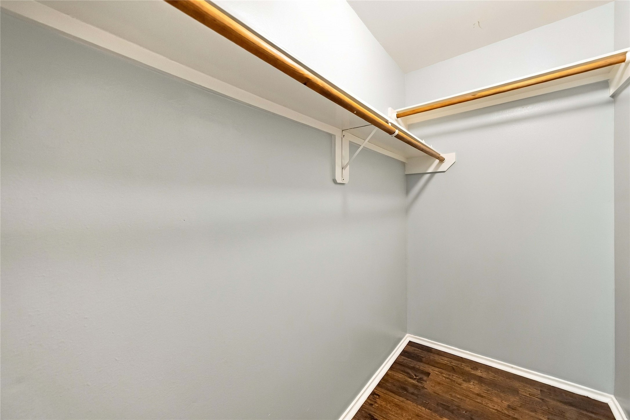 Large walk-in closet provides extensive hanging space and room for organized wardrobe storage.