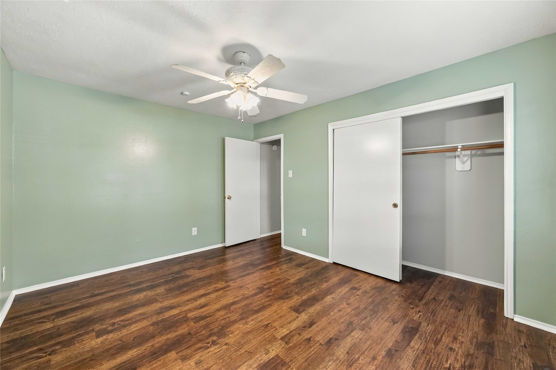 Secondary bedroom includes a wide closet with sliding doors and plenty of room for flexible furniture placement.