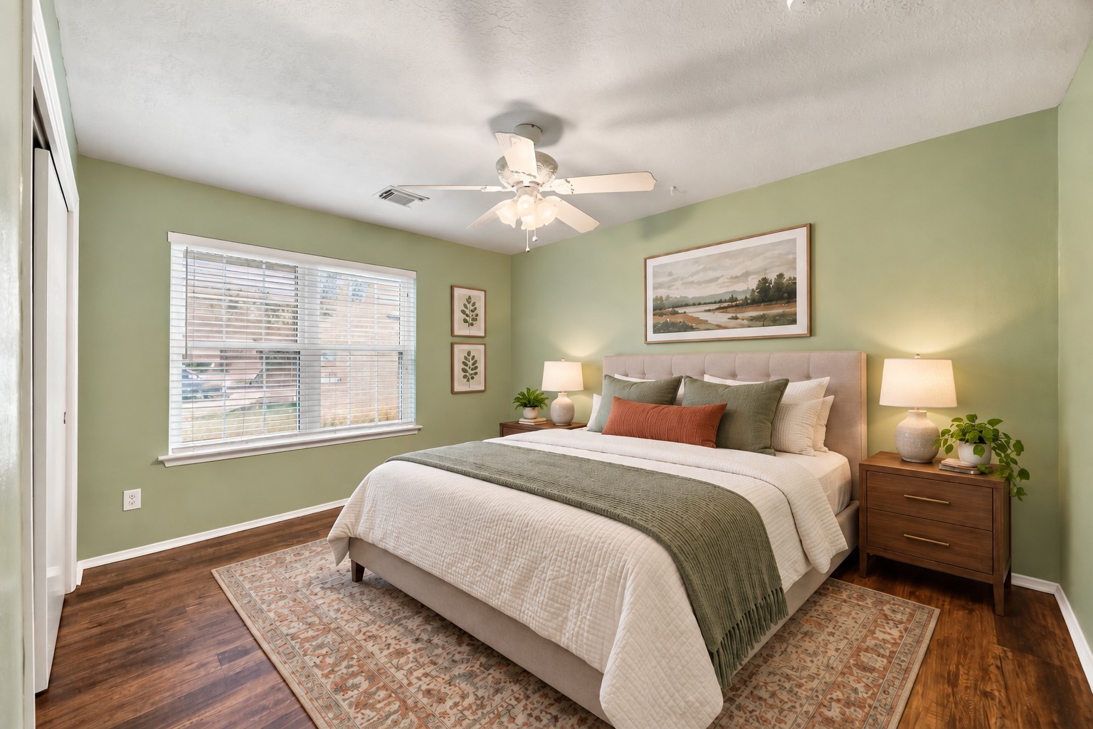 Bright secondary bedroom offers generous floor space, wood-look flooring, a ceiling fan, and ample natural light.**Photo has been virtually staged