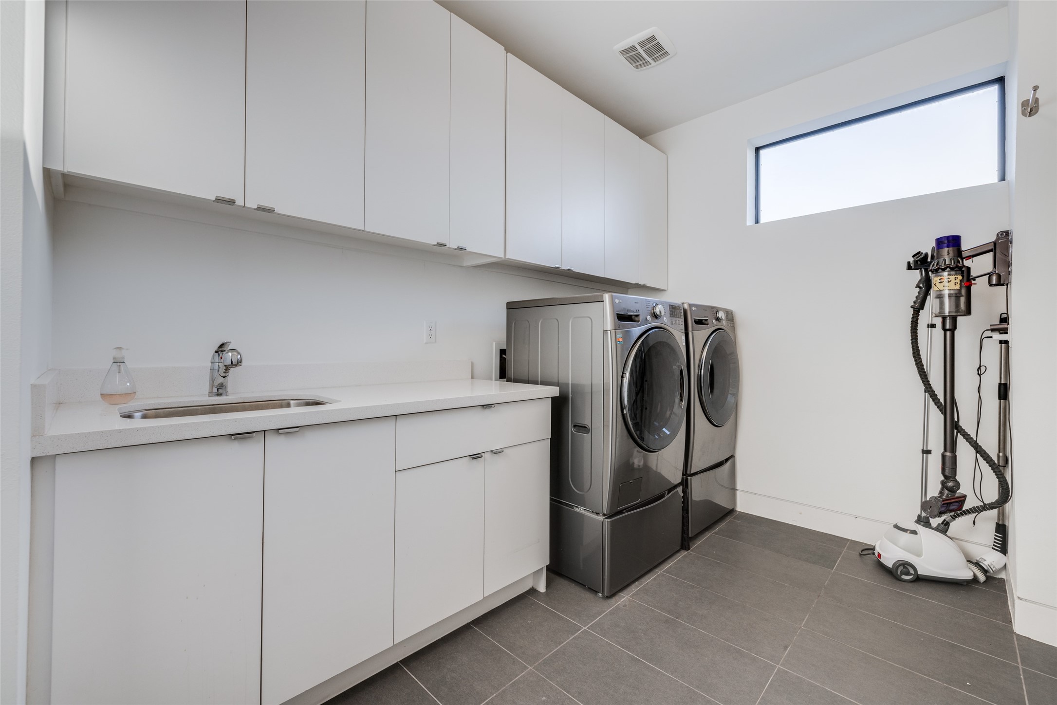 Second floor laundry, tile floor, washer & dryer included in sales price, sink for cleaning sports kits etc, lots of storage cabinets