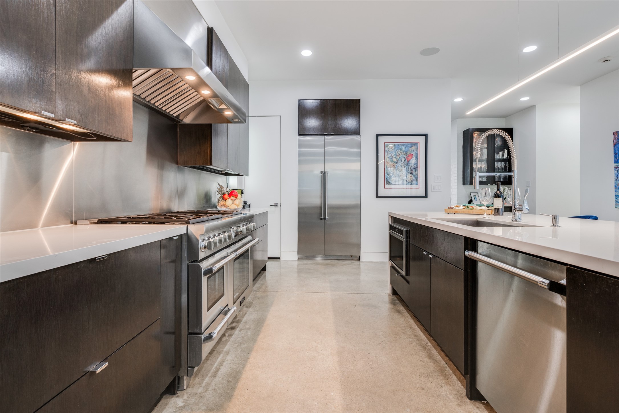 Enjoy cooking in this wonderful high end kitchen, dark stained cabinets with soft closing upper & lower cabinets & drawers, easy to maintain polished concrete floors