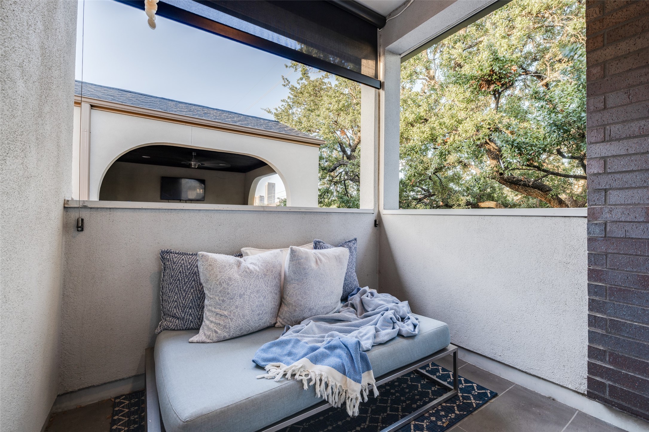 Third floor covered balcony out from the study with recently added privacy motorized blind.