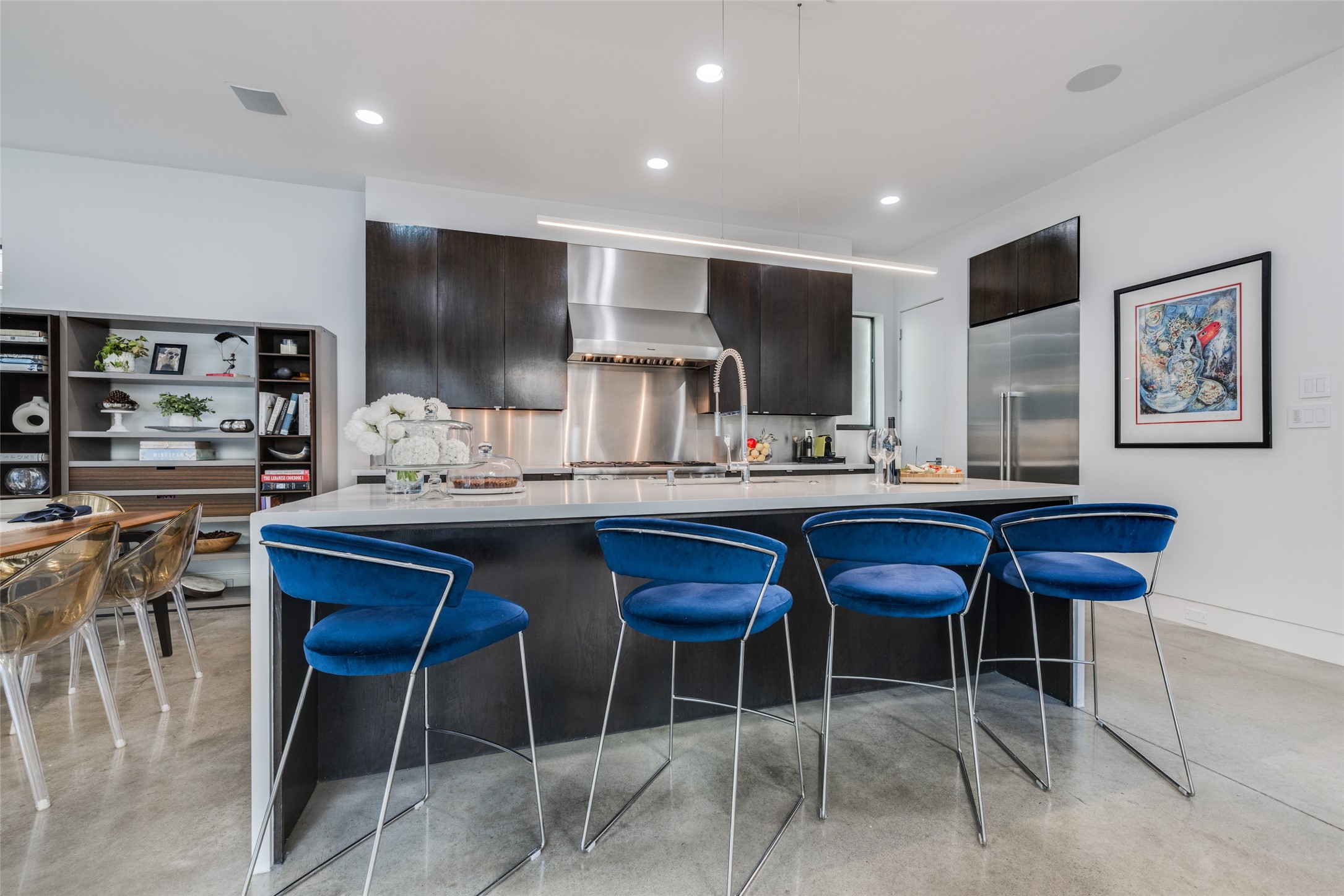 Huge Breakfast Island with counter height seating niche, white quartz countertops, waterfall edge, lights controlled by app through out main areas of the home.