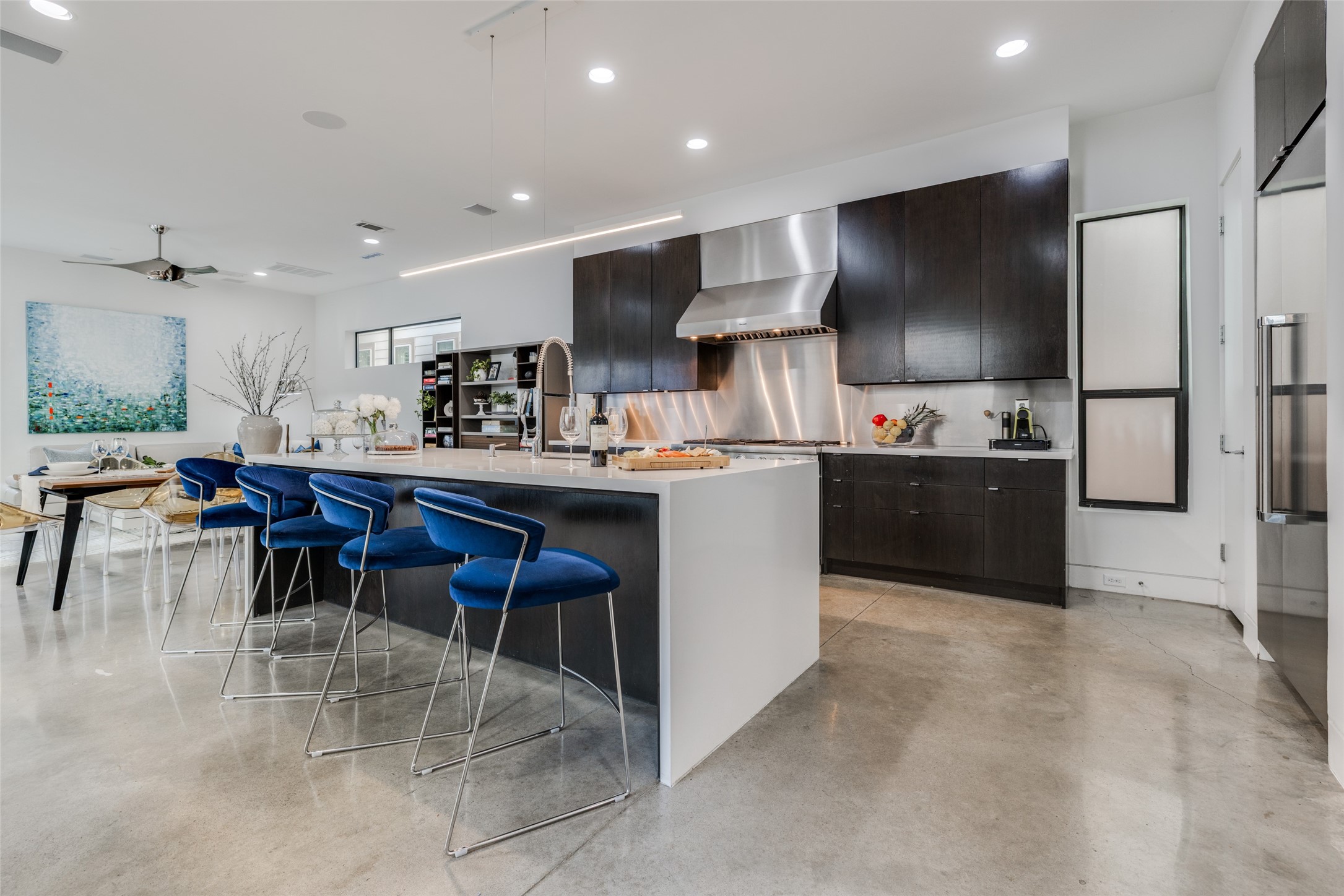 Gourmet Chef's Dream Kitchen with Thermador Professional Package - Range with 6 Burners, griddle, double oven, second is steam, warming drawer, hood, SS refrigerator, SS backsplash, huge island with white quartz counter top, waterfall edge & SS sink with chrome Hansgrohe faucet