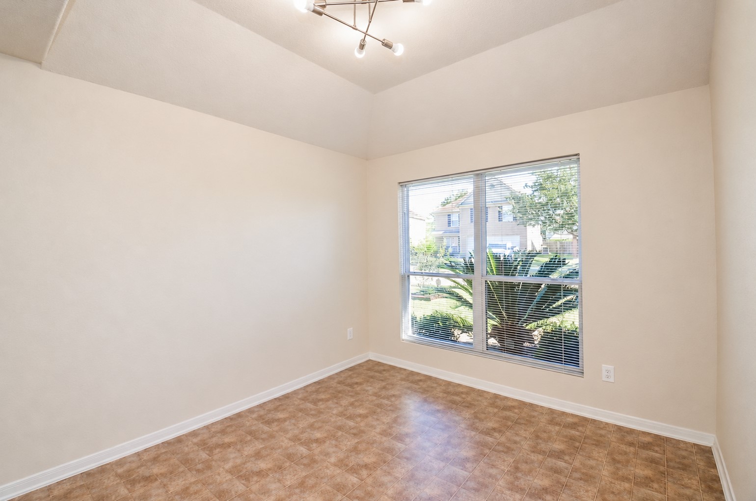 Additional view of the formal dining room highlighting the generous floor space, natural light and architectural ceiling details.