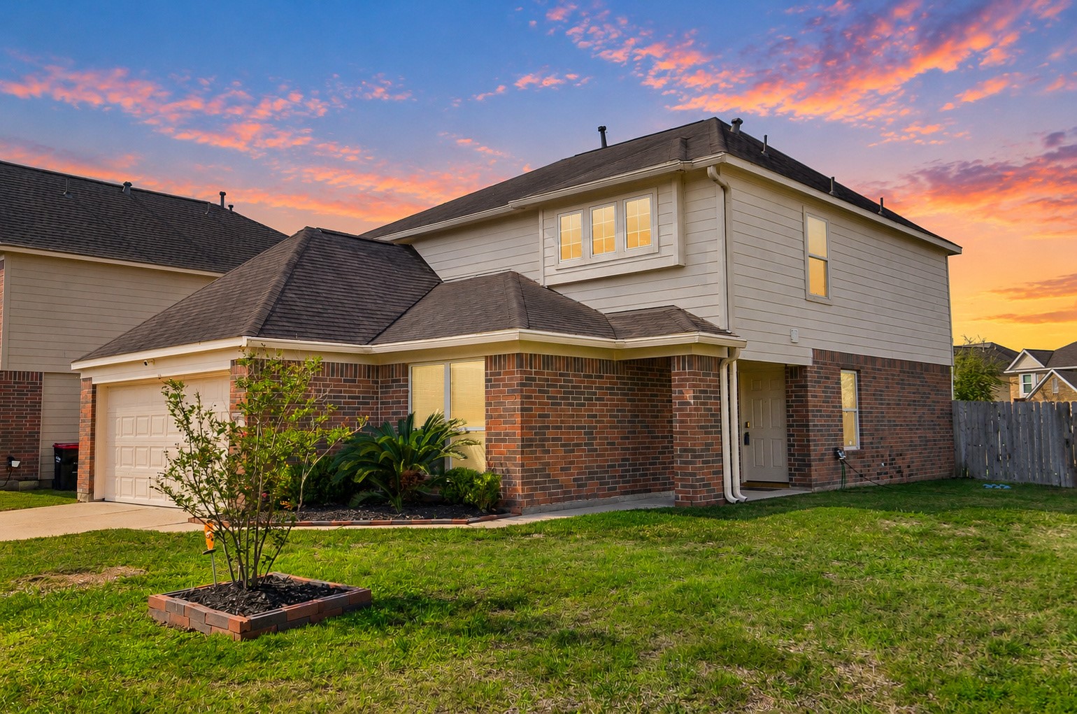 Additional exterior view highlighting the home's two-story design, landscaping and generous corner lot.