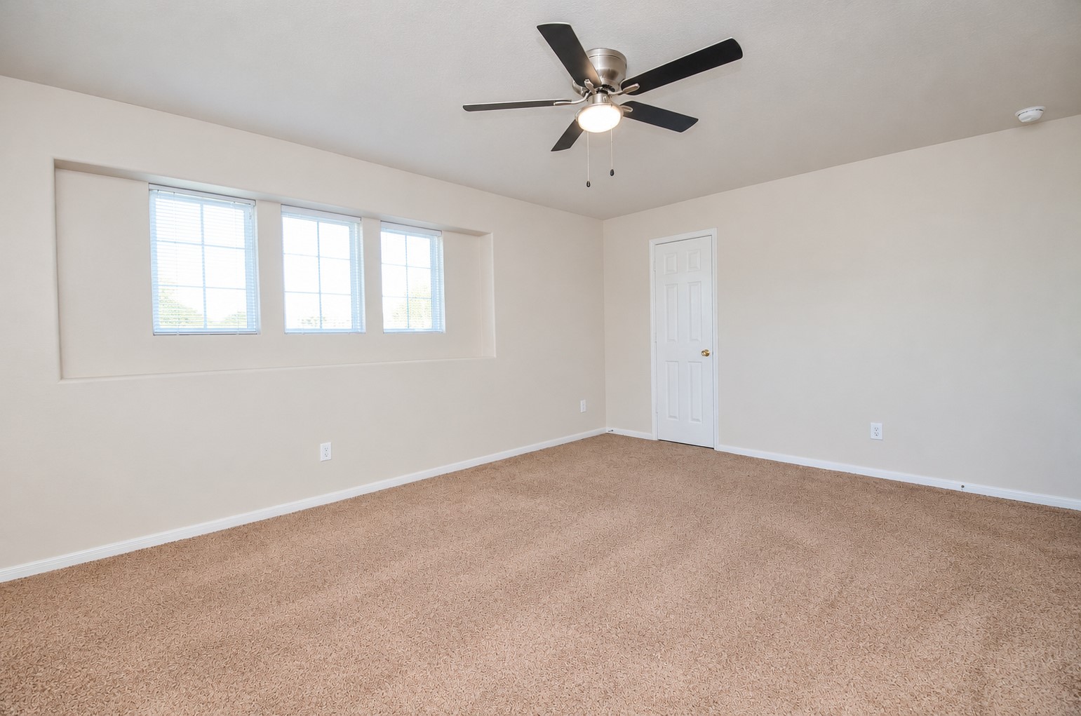 Spacious second-floor bedroom offering the flexibility to serve as a second primary bedroom, with ample room for a king-size bed and additional furnishings.