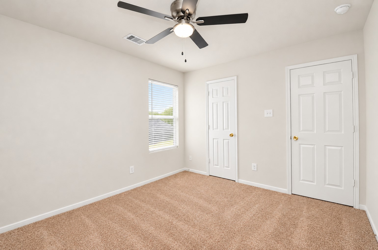 Additional view of the third bedroom highlighting the spacious layout, natural light and closet access.