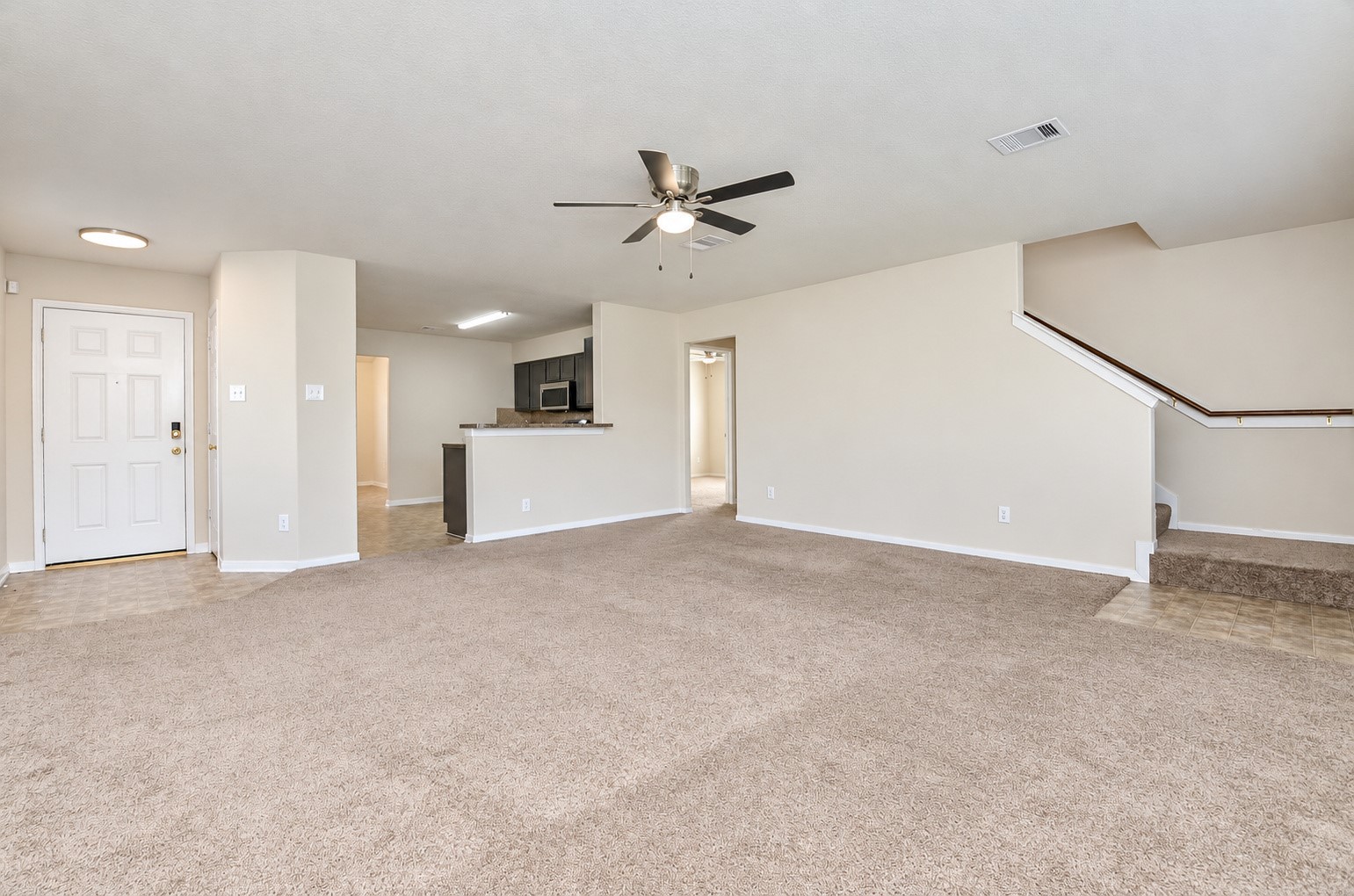 Open-concept family room with convenient access to the kitchen, staircase and additional living spaces.