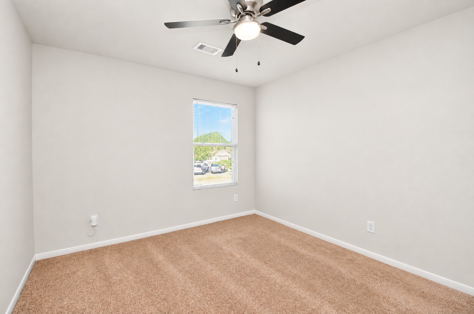 Additional view of the fourth bedroom showcasing the flexible floor space, ideal for a bedroom, home office or guest room.
