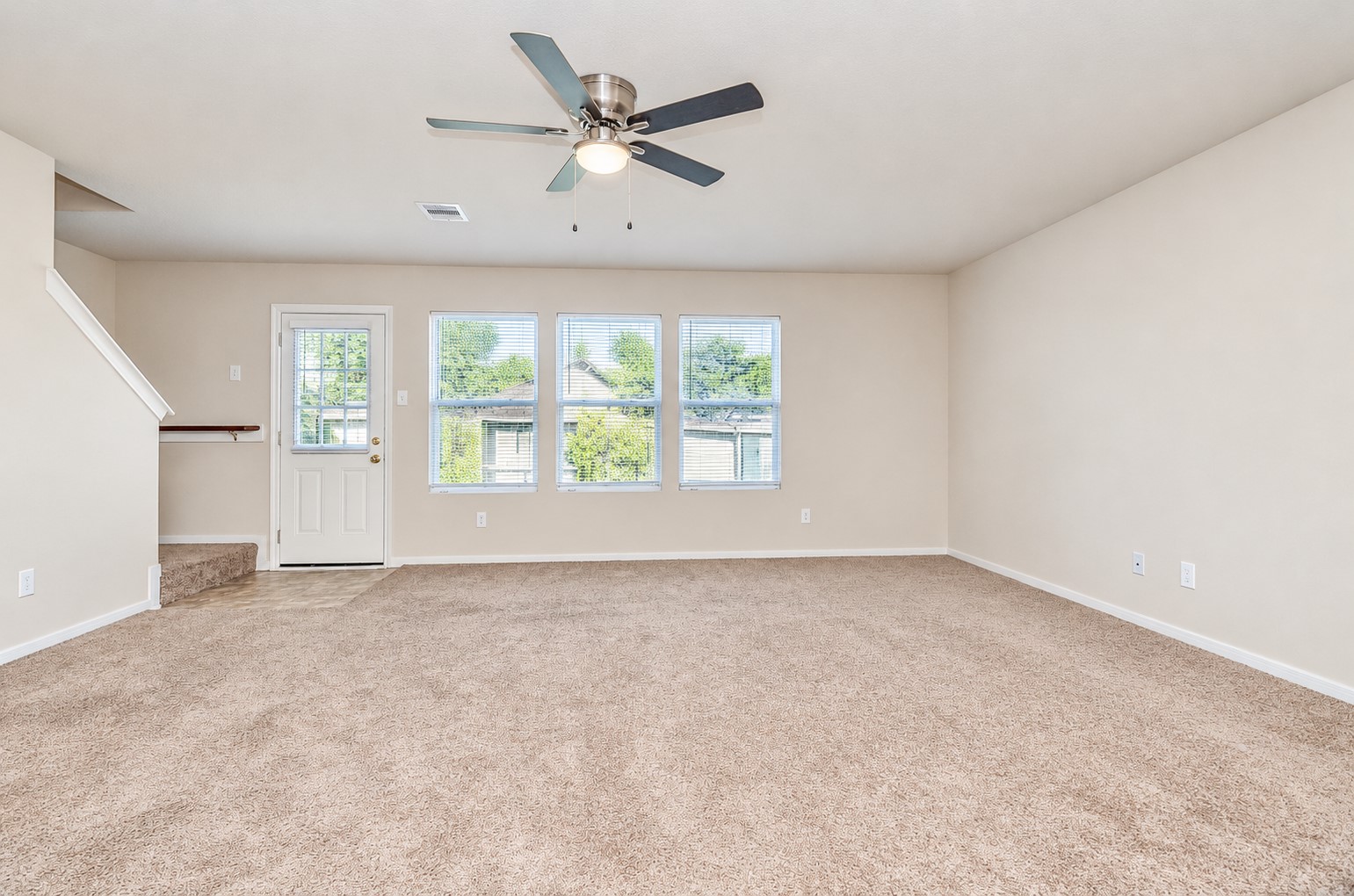 Expansive family room with large windows overlooking the backyard and plenty of space for relaxing or entertaining.