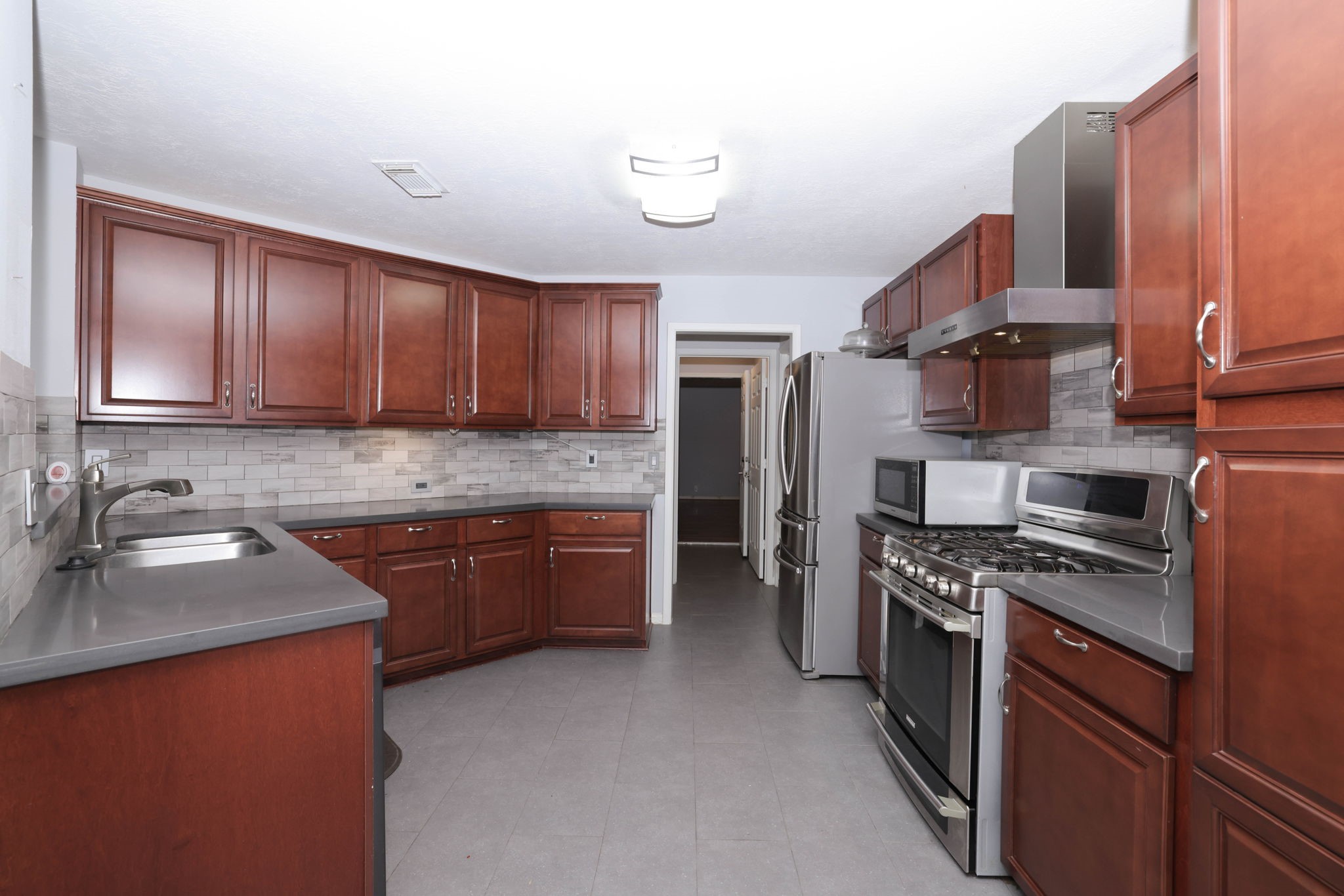 Kitchen features lots of cabinets and counters for meal prep and entertaining!