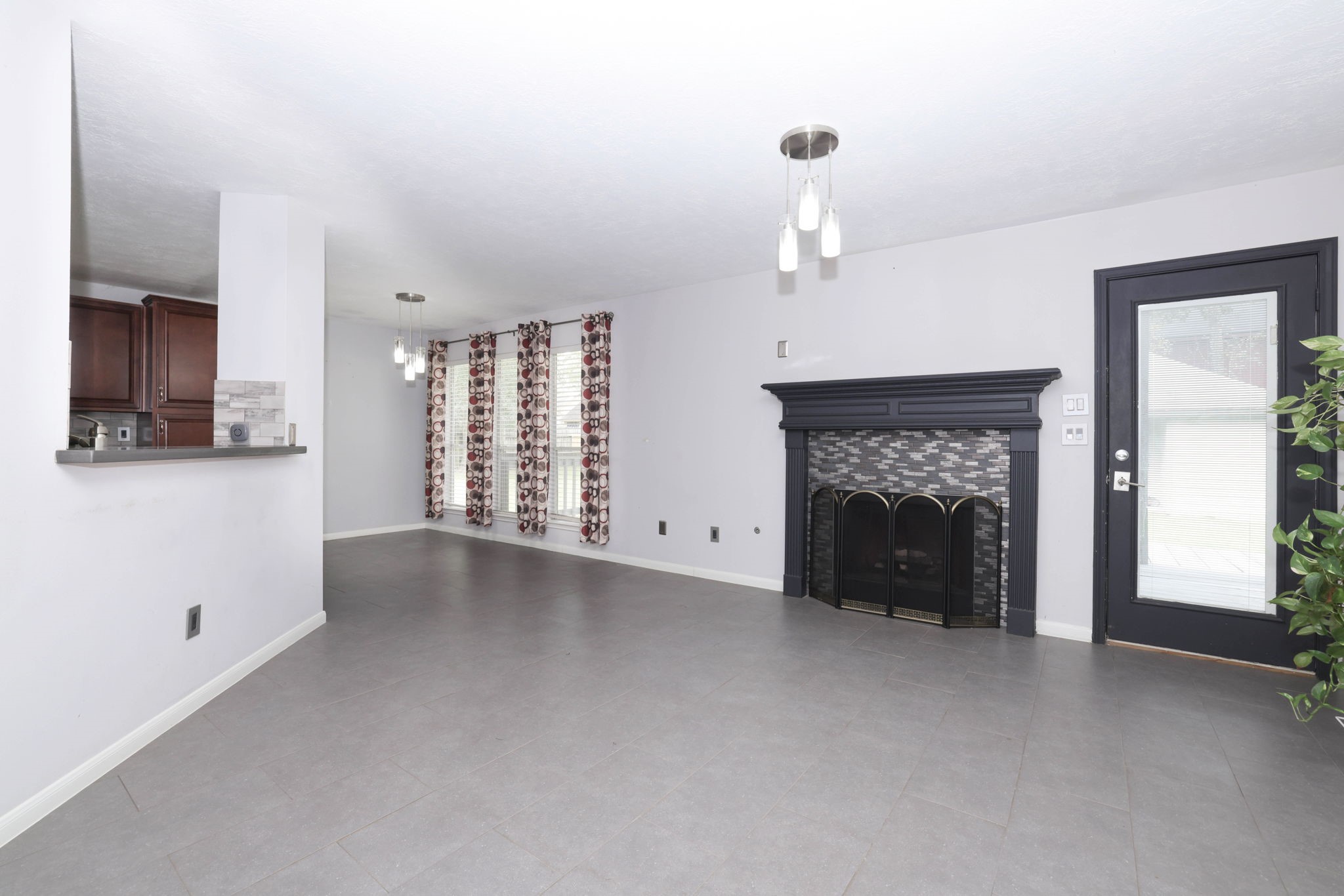 Family room features gas log fireplace, door to back patio and tile floors throughout!