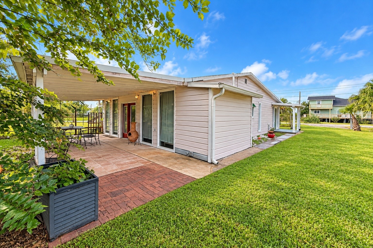 Large outdoor patio just off the Primary Bedroom located at the back of the house. Large outdoor patio just off the Primary Bedroom located at the back of the house.