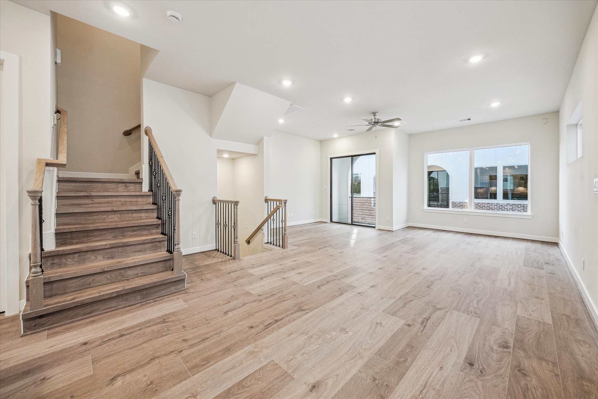 Spacious second-floor living area featuring a private balcony just off the main living space.