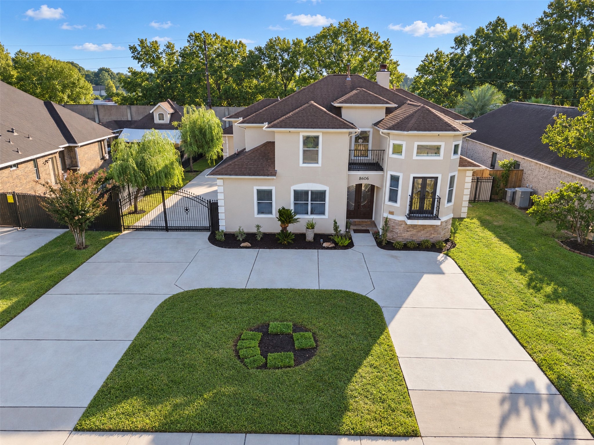 Gated Driveway: An ornamental iron gate adds a distinctive finishing touch to the driveway entrance.