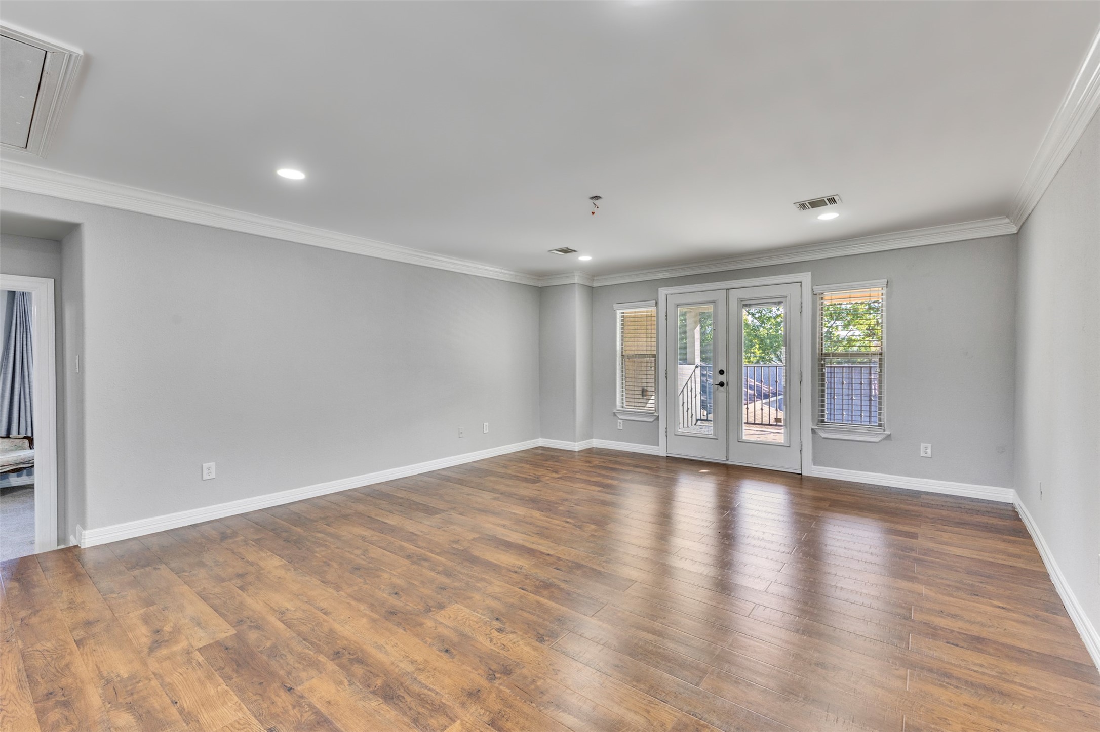 An expansive game room with an impressive balcony offers exceptional space for entertaining, relaxing, and enjoying indoor-outdoor living.