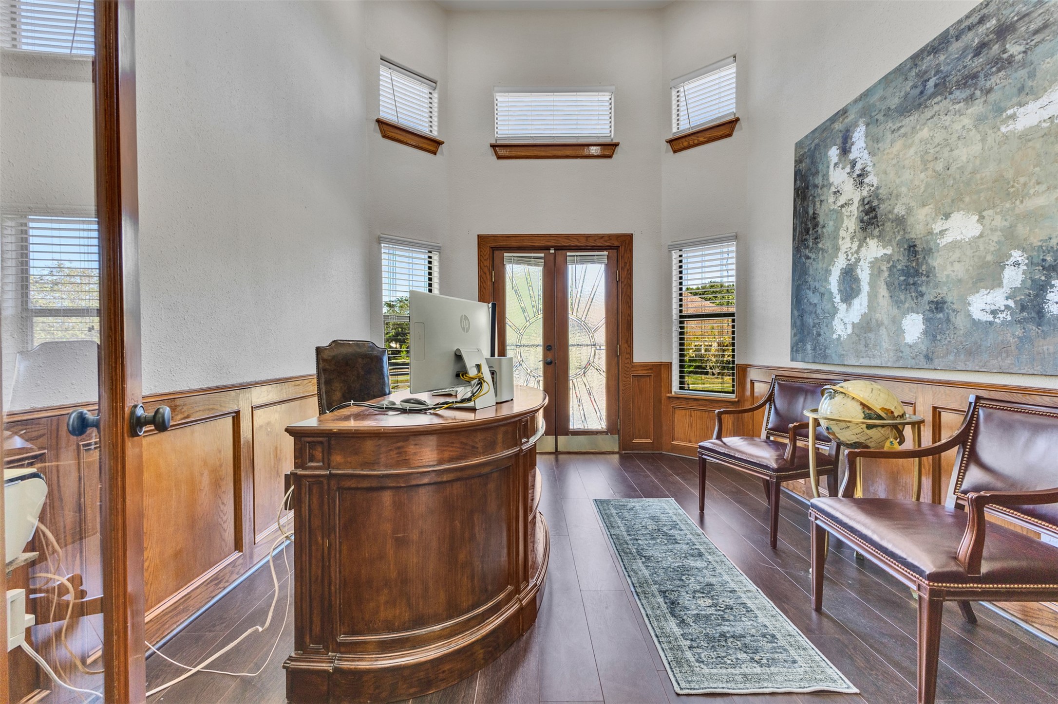 A stunning home office featuring an impressive balcony and abundant natural light, creating an inspiring space for work or study.