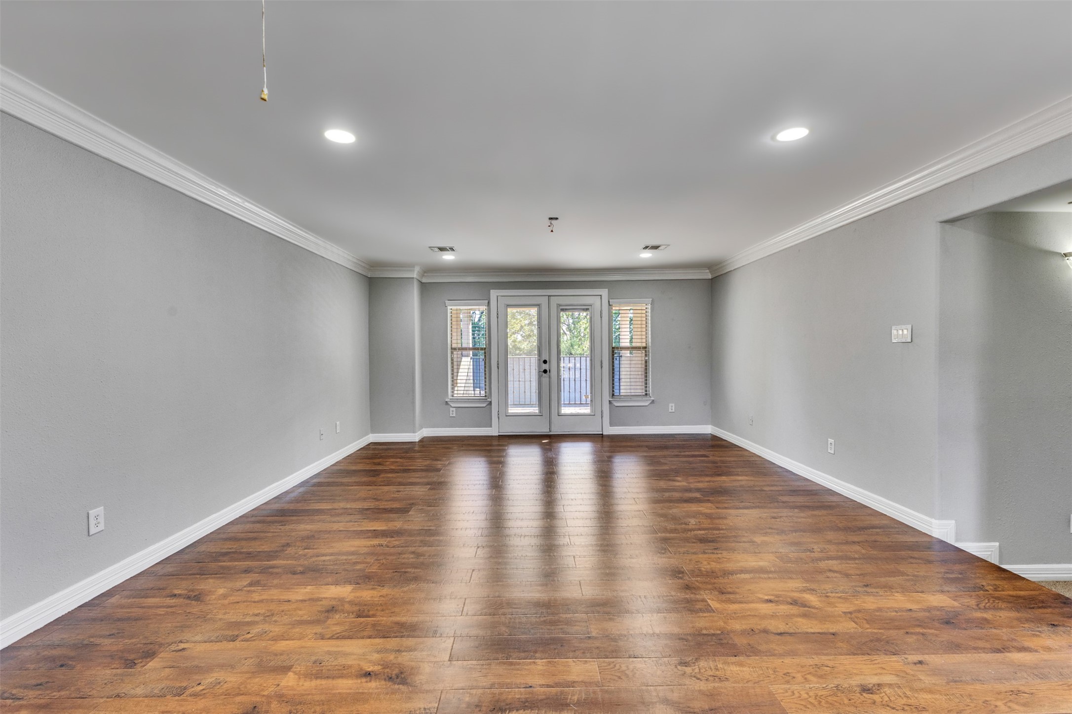 An expansive game room with an impressive balcony offers exceptional space for entertaining, relaxing, and enjoying indoor-outdoor living.