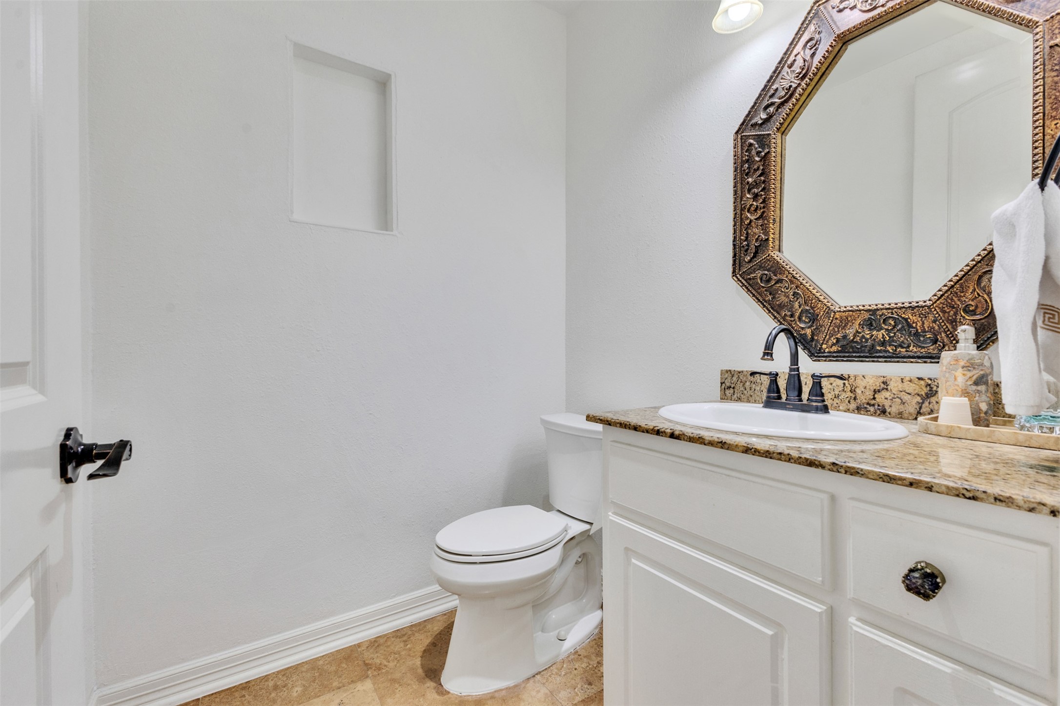 Conveniently located half bath offers added comfort for guests while keeping the homes private bathrooms separate.