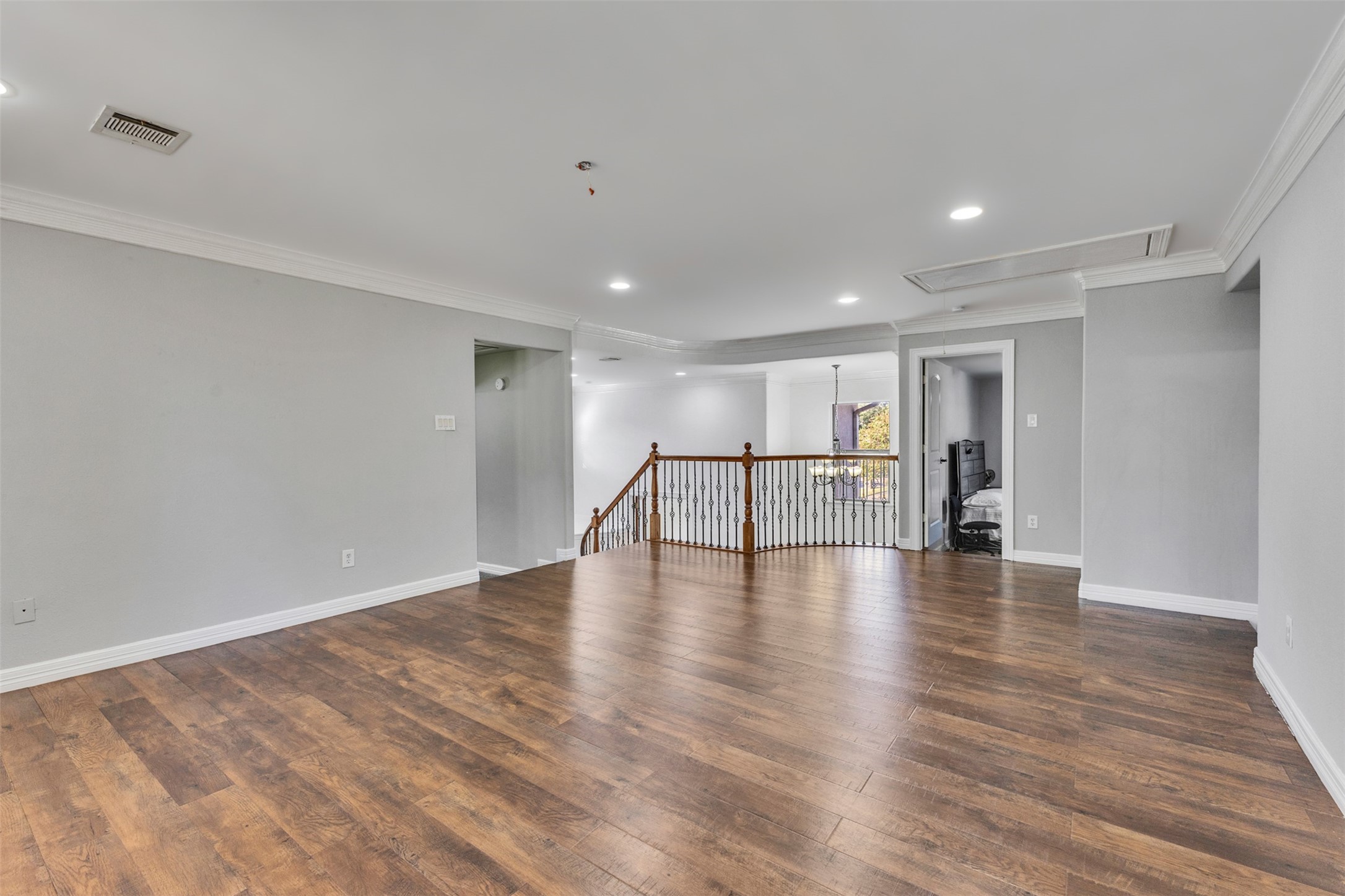 An expansive game room with an impressive balcony offers exceptional space for entertaining, relaxing, and enjoying indoor-outdoor living.