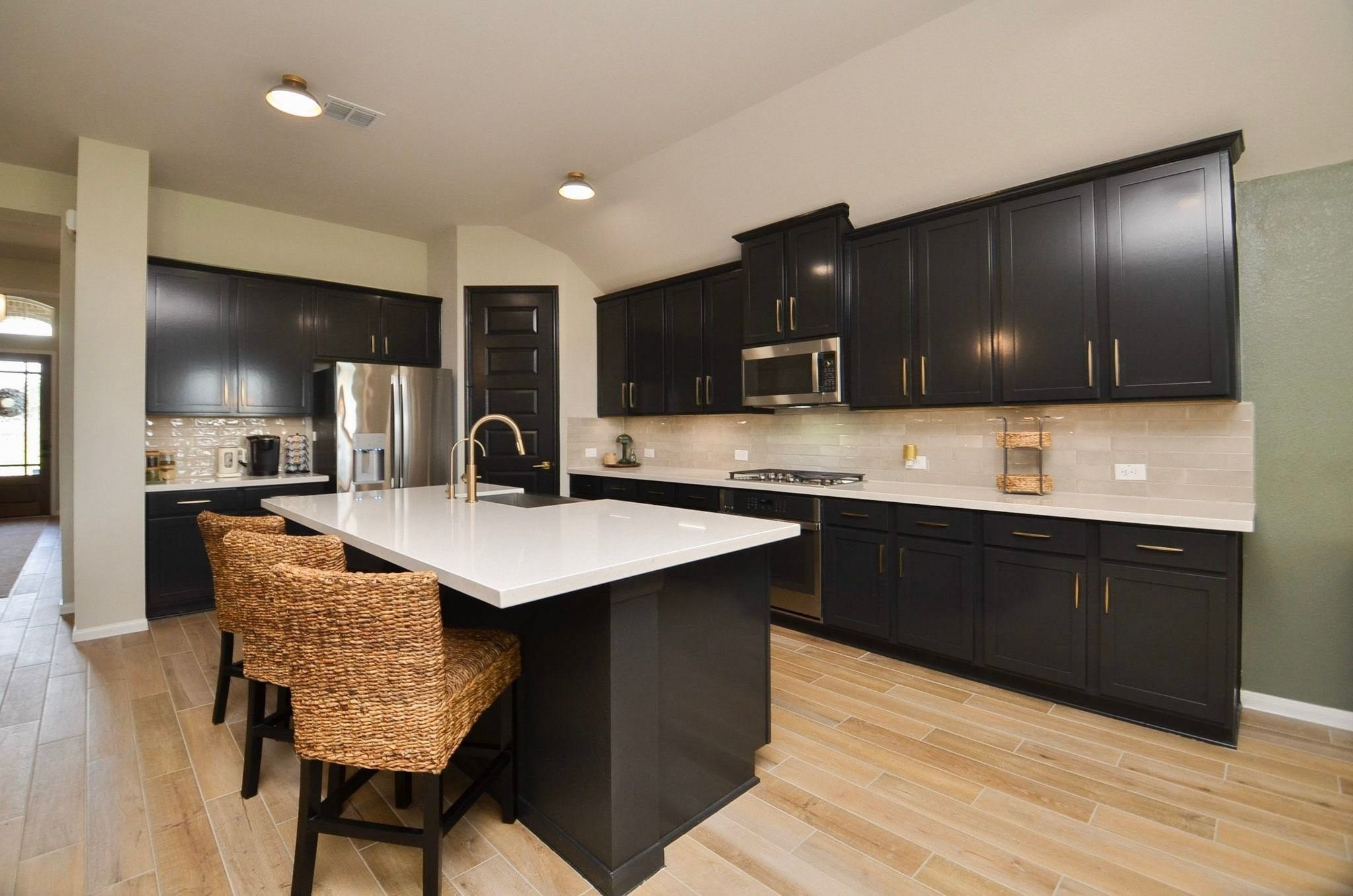 Quartz countertops and beautiful subway tile backsplash. BIG island for extra seating!