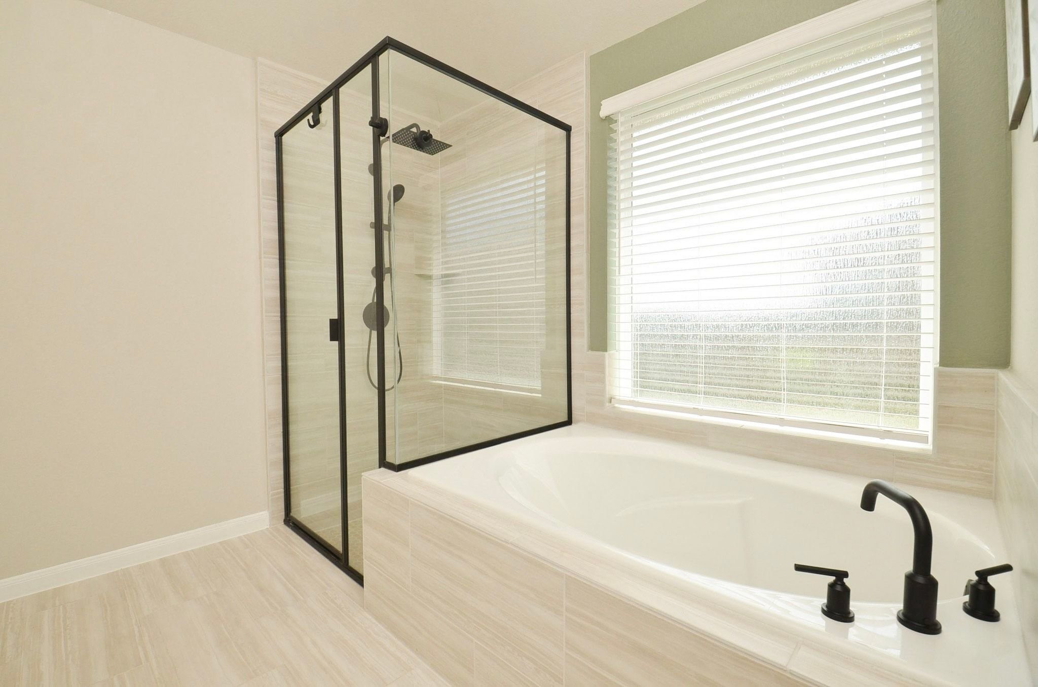 Primary en suite with large glass enclosed shower and soaking tub