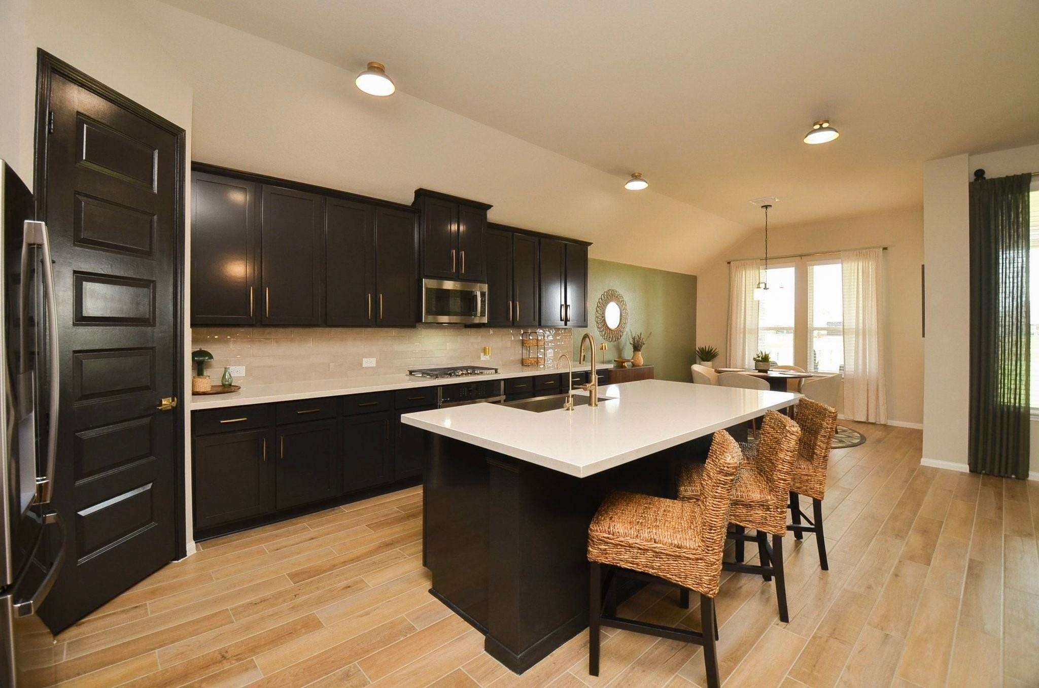 Wood-look tile, spacious pantry, under cabinet lighting and beautiful cabinet hardware