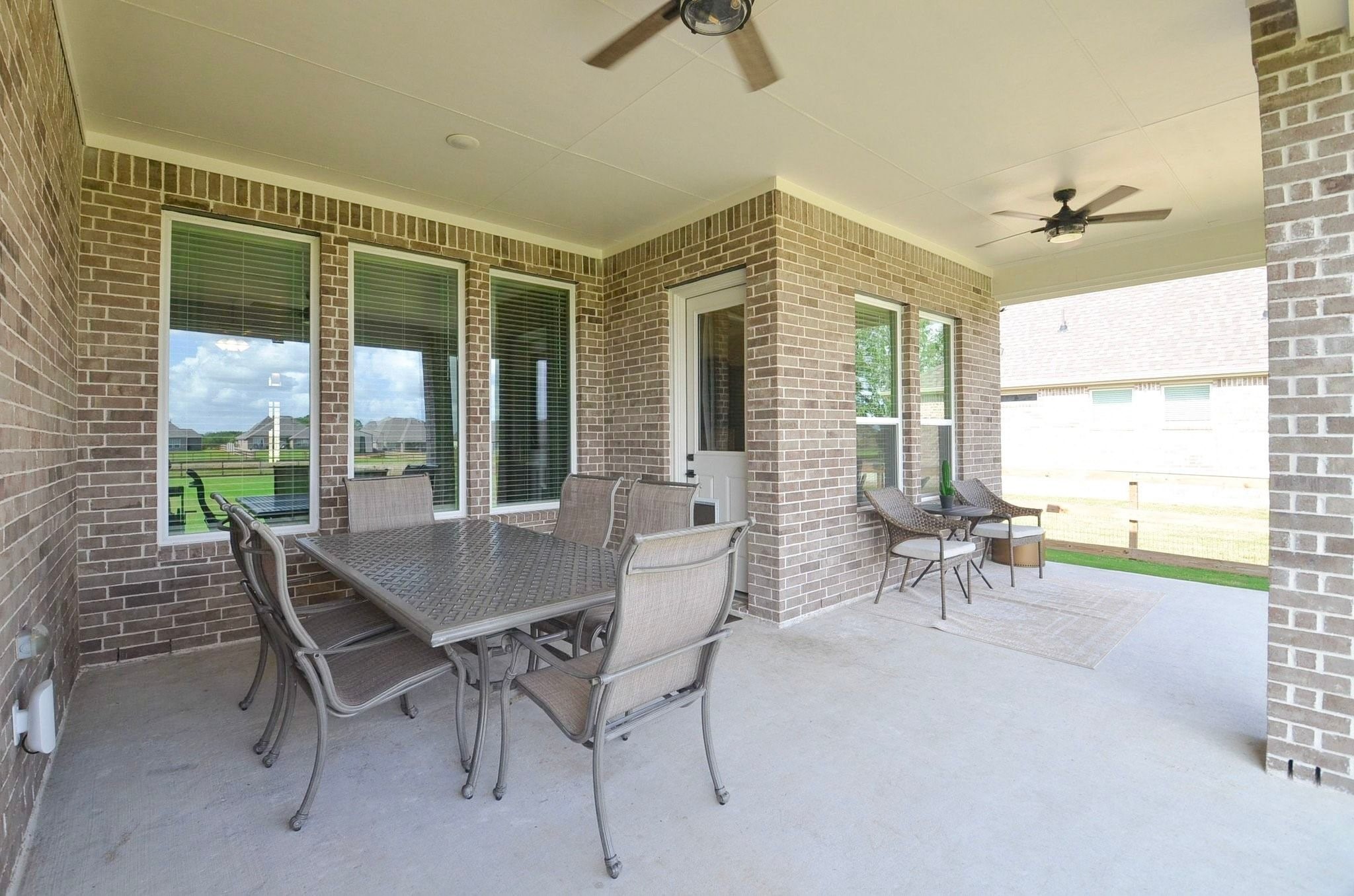 Extended covered patio with two ceiling fans- a great spot to relax after a long day!
