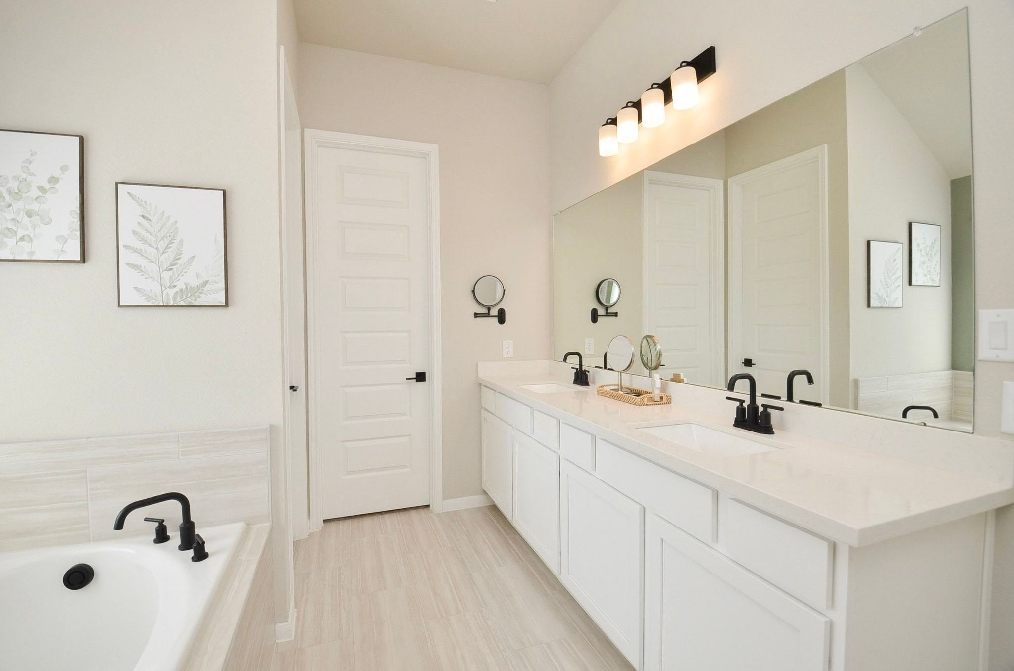 Primary bath- double sinks, large countertop and plenty of cabinet space/storage