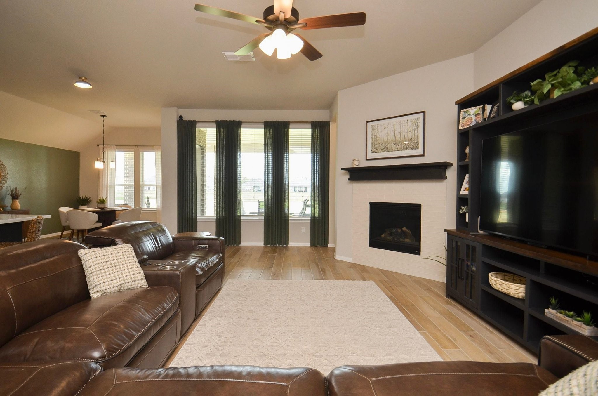 Spacious family room with beautiful fireplace & mantle and lots of natural light