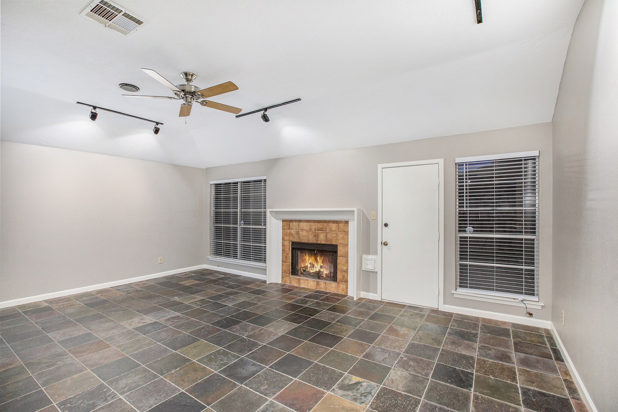 Large family room features stunning slate floor, track lighting, gaslog fireplace with tile surround and direct access to the backyard. Large family room features stunning slate floor, track lighting, gaslog fireplace with tile surround and direct access to the backyard.
