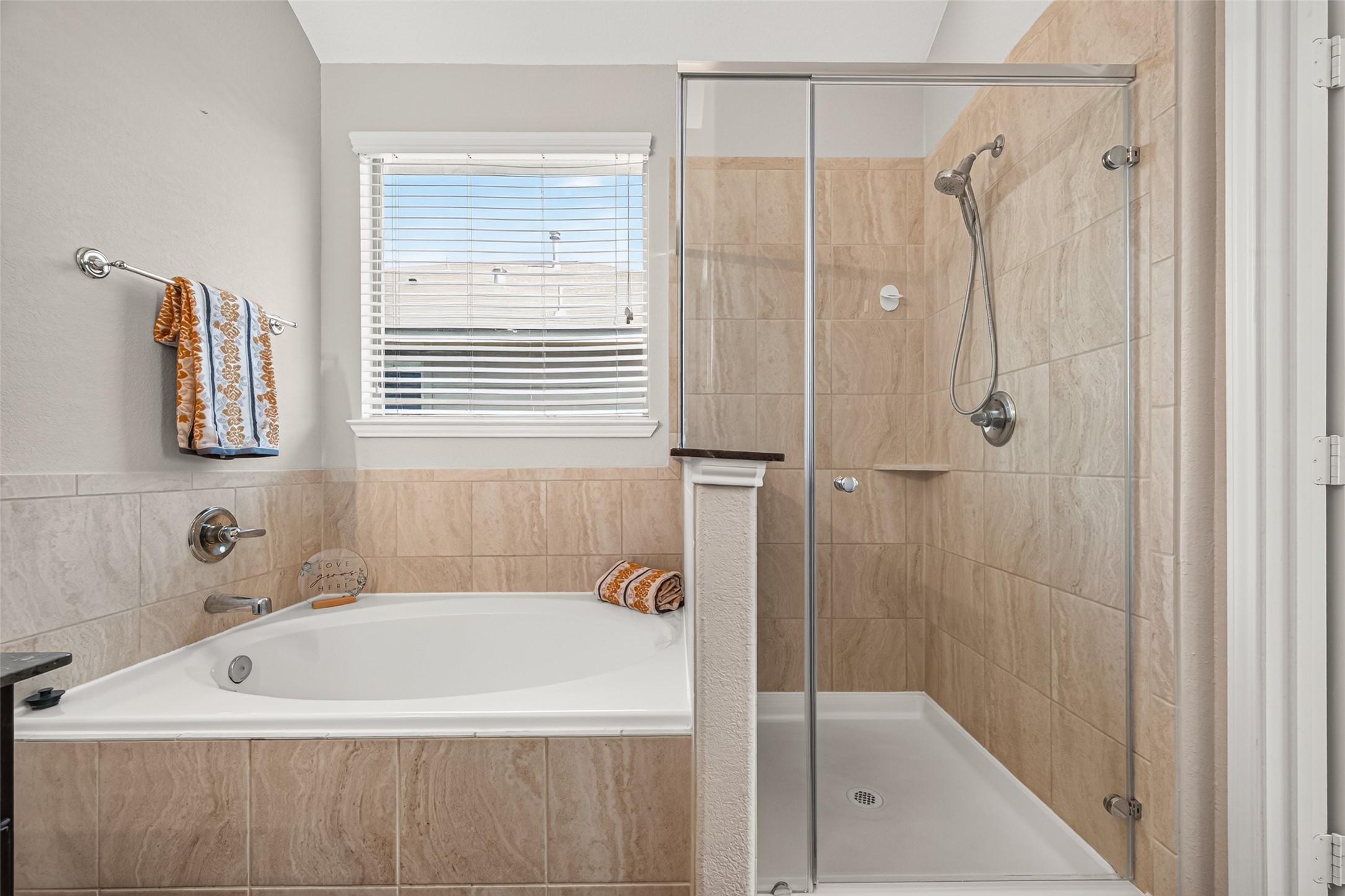 Wheter you prefer a relaxing soak or a quick shower, this primary bathroom offers the flexibility of both.