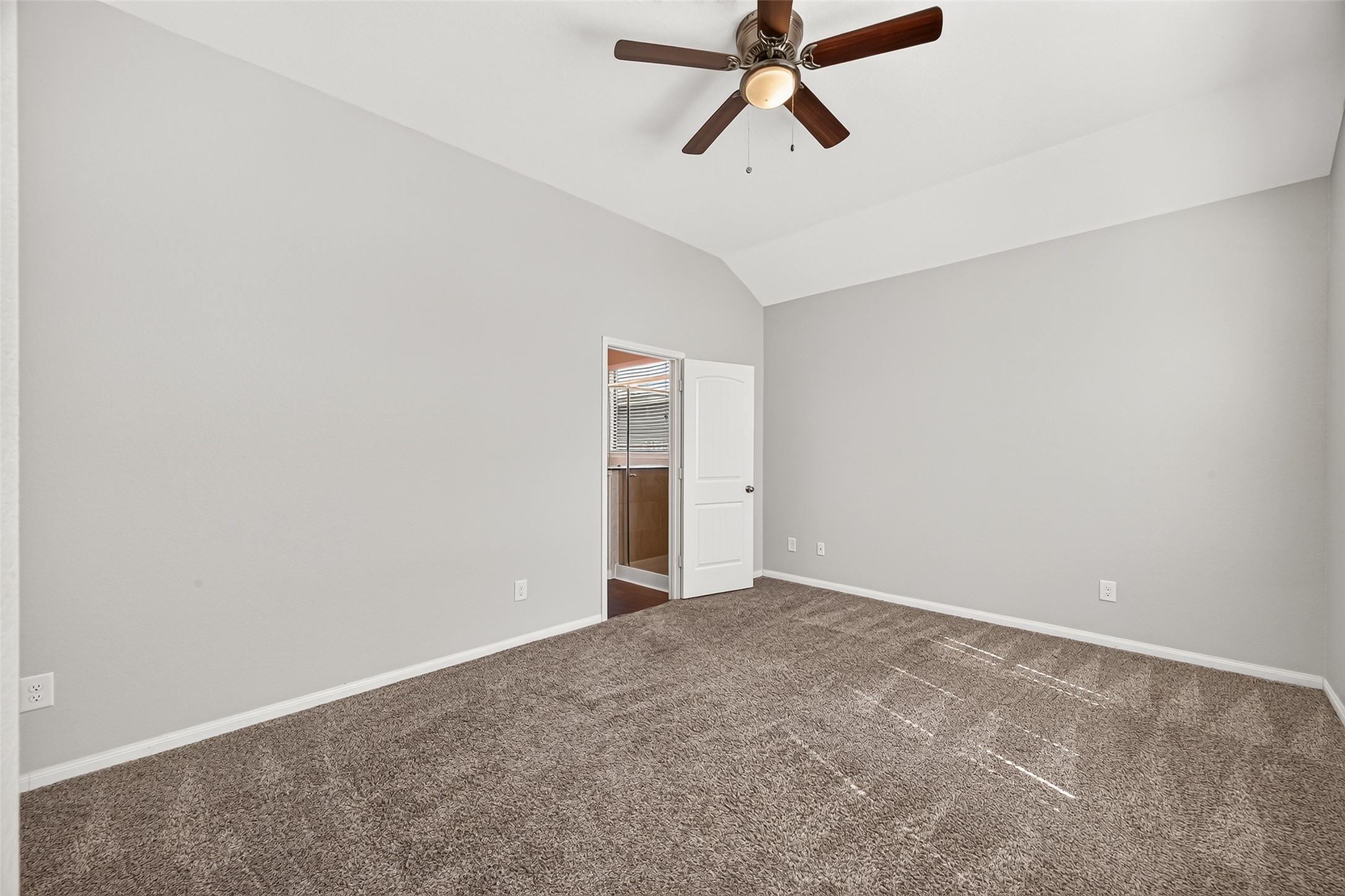 Primary bedroom with direct access to the en suite bathroom.