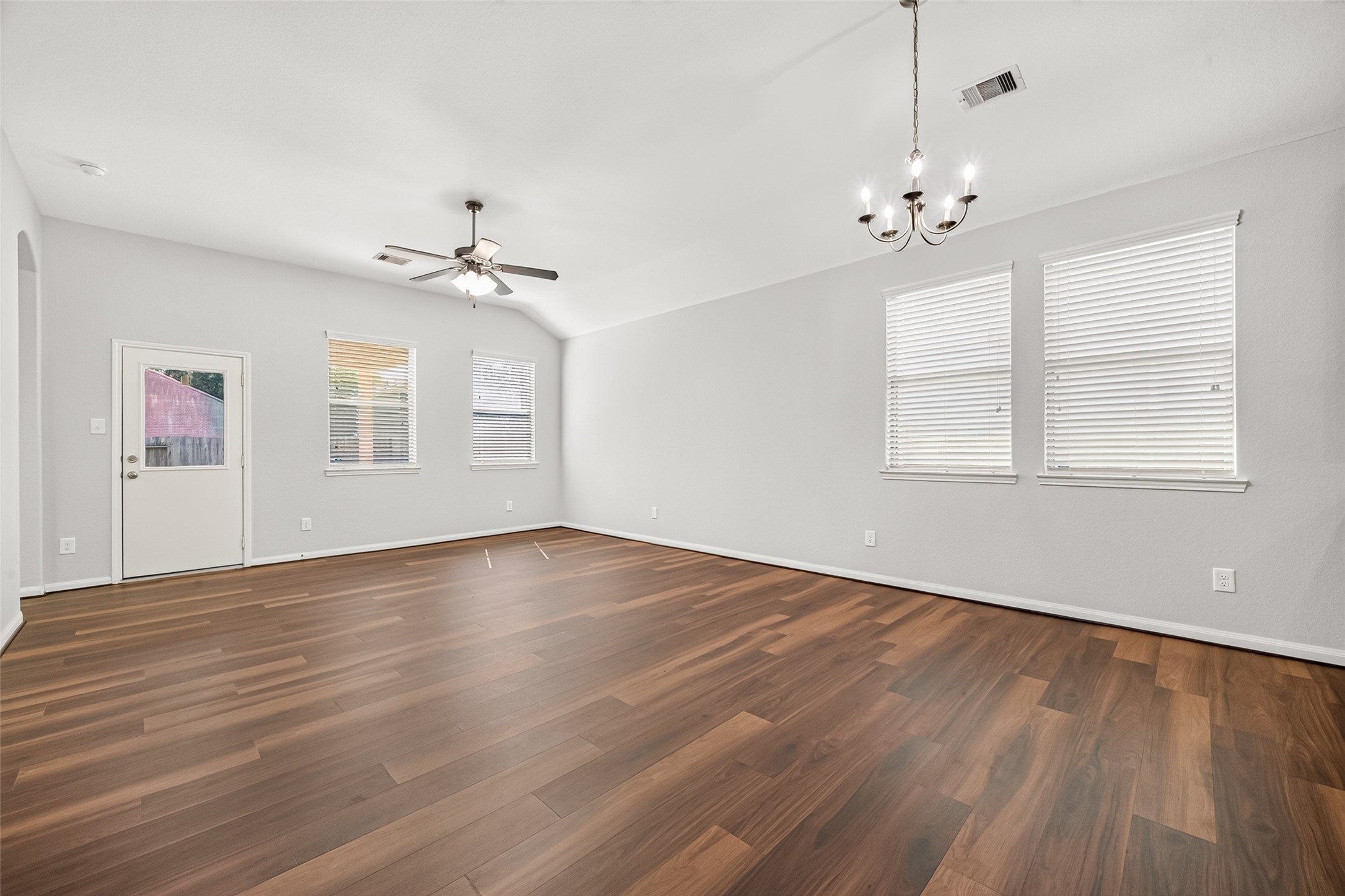 Natural light pours through the living room windows, giving the space a bright and cheerful feel.