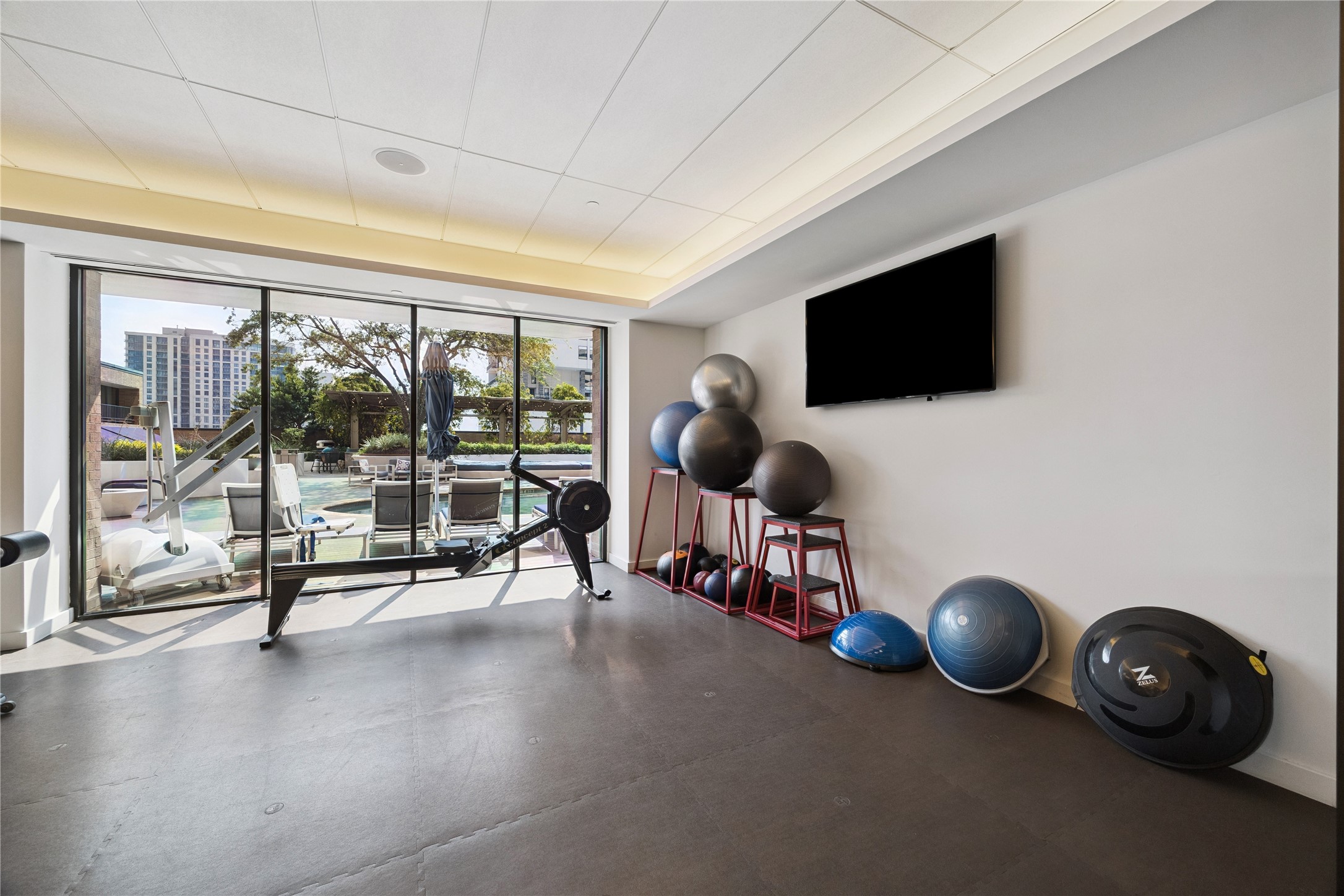The studio offers natural light and serene views of the pool deck, making it a calming spot for yoga, Pilates, or recovery work. Equipped with balance balls, mats, and functional gear, it complements the larger Four Seasons fitness center.